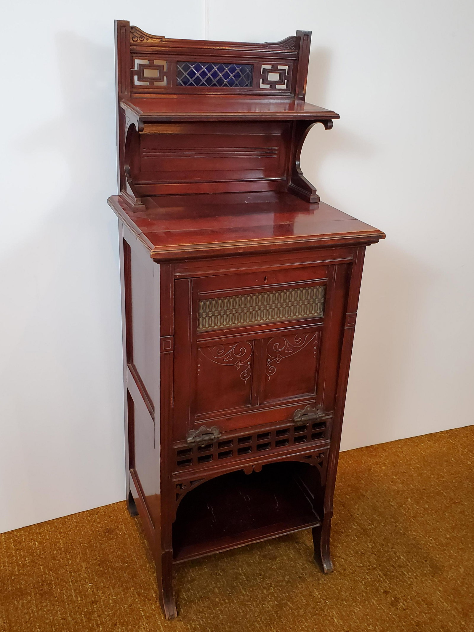 Victorian Parlor Cabinet: Mahogany. Leaded glass top panel. 20 1/2" wide X 16" deep X 52" high. IMPORTANT: Before bidding, please read the terms and conditions. When you registered for the auction you agreed to these terms and