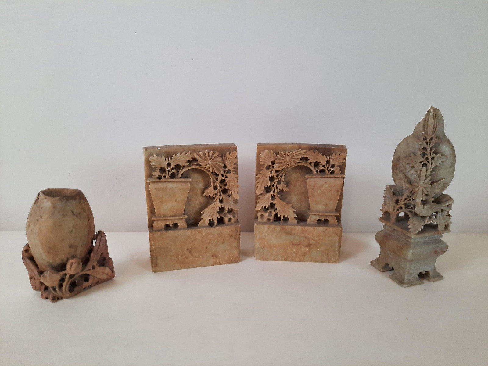 4 Pcs Soapstone Bookends and Vases: 4" to 7" high. One bookend with repair. IMPORTANT: Before bidding, please read the terms and conditions. When you registered for the auction you agreed to these terms and will be required to comply wi