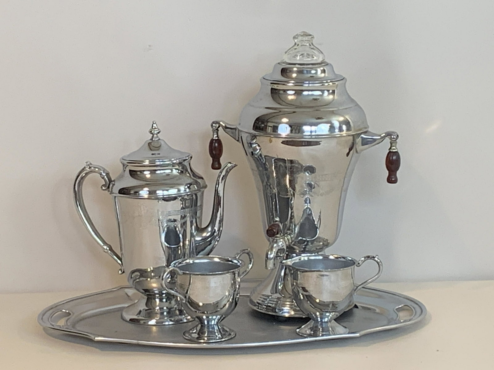 5 Pc G. B. Chrome Plated Coffee & Tea Service: No cord. 14” tall, tray 19” wide. IMPORTANT: Before bidding, please read the terms and conditions. When you registered for the auction you agreed to these terms and will be required to comply with