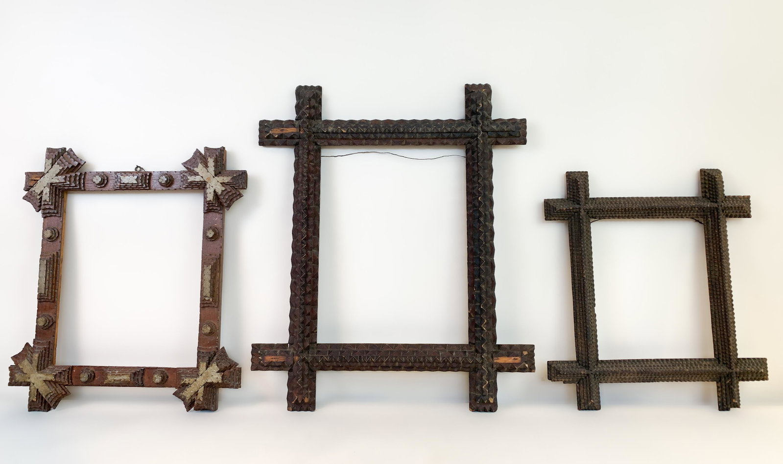 3 Tramp Art Frames: Largest opening 13-1/2” x 9-3/4”. Largest frame with some losses. IMPORTANT: Before bidding, please read the terms and conditions. When you registered for the auction you agreed to these terms and