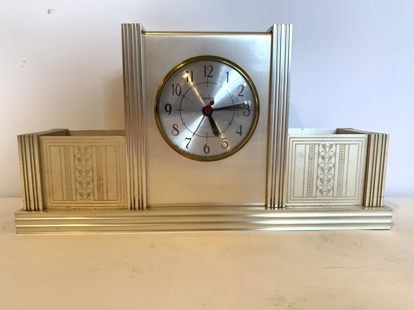 Norbin Aluminum Desk Clock: Working. 15" wide x 7-3/4" high x 4-3/4" deep. IMPORTANT: Before bidding, please read the terms and conditions. When you registered for the auction you agreed to these terms and will be required to co