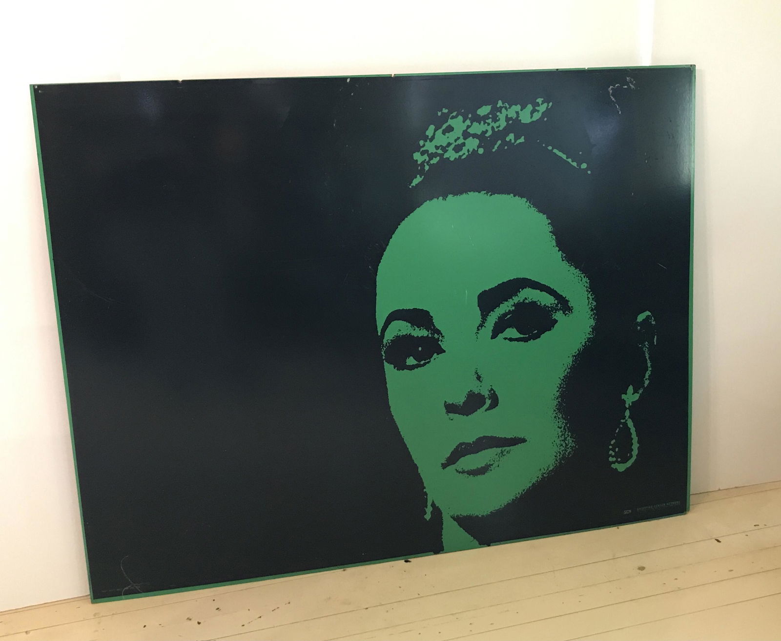 Elizabeth Taylor 44" x 58": Shopping Center Network poster on masonite. 44 “ high x 58 “ wide. IMPORTANT: Before bidding, please read the terms and conditions. When you registered for the auction you agreed to these terms an
