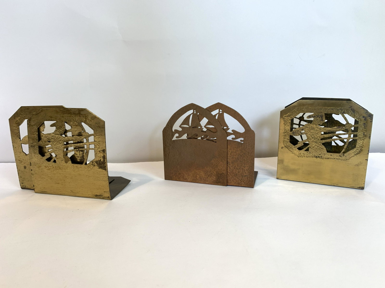 Hand Hammered Bookends and Letter Holder: 2 pairs of bookends. Archer 5” high x 5” wide, sailboat 5” high x 4” wide. Letter holder 5” high x 5” wide. IMPORTANT: Before bidding, please read the terms and conditions. When you regist