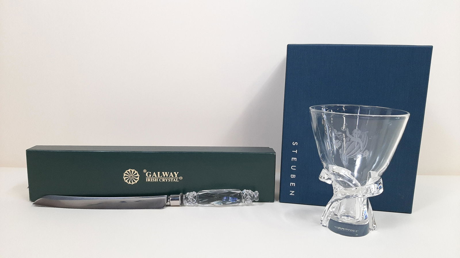 Steuben Hershey Vase and Galway Cake Knife: Vase: 4-3/4" diameter X 6-1/2" high. Knife: 13-3/4" long. Each with original box. IMPORTANT: Before bidding, please read the terms and conditions. When you registered for the auction you agreed to the