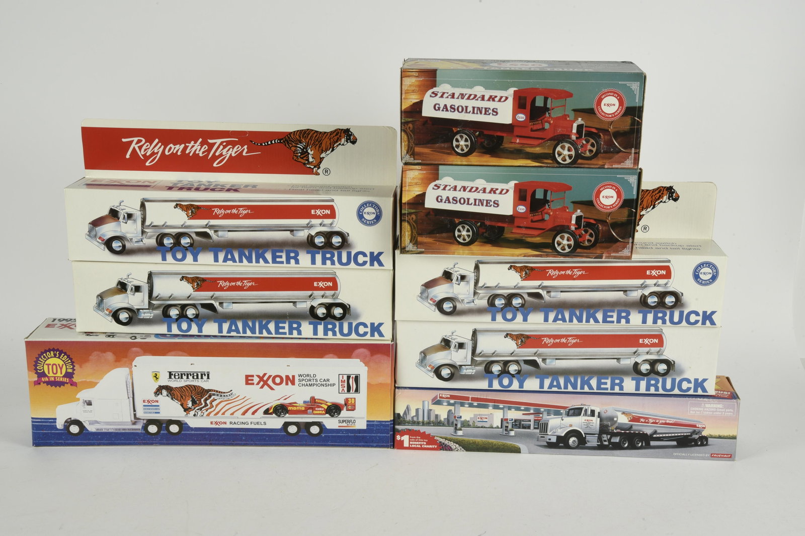 9 Die-Cast Exxon Trucks: Includes tanker cars and race car carrier. All unused in original boxes. Boxes with shelf wear. IMPORTANT: Before bidding, please read the terms and conditions. When you registered for the auction you