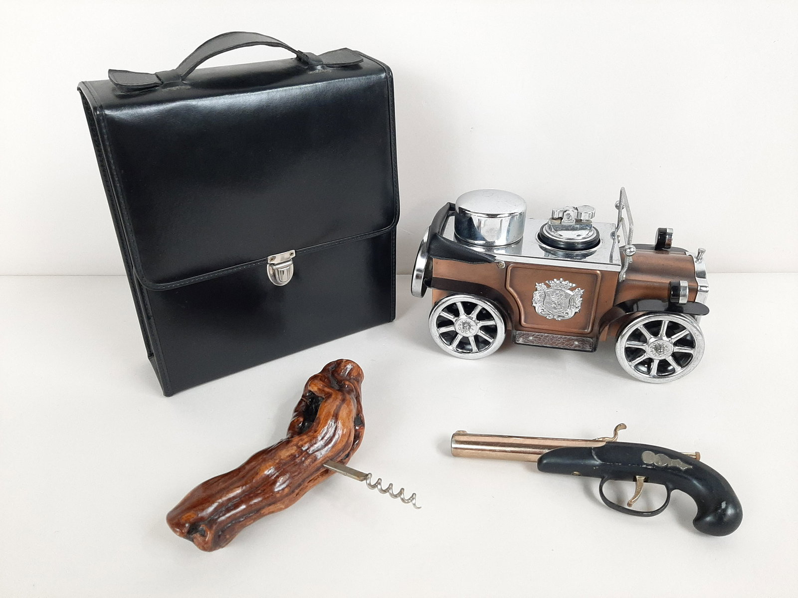 4 Pcs incl. Vintage Cigarette Lighter Car: Also includes spirits carrier case, corkscrew, and pistol lighter. Car: 10" long X 5-1/2" high. Case: 9" wide X 10" high. IMPORTANT: Before bidding, please read the terms and conditions. When you regi