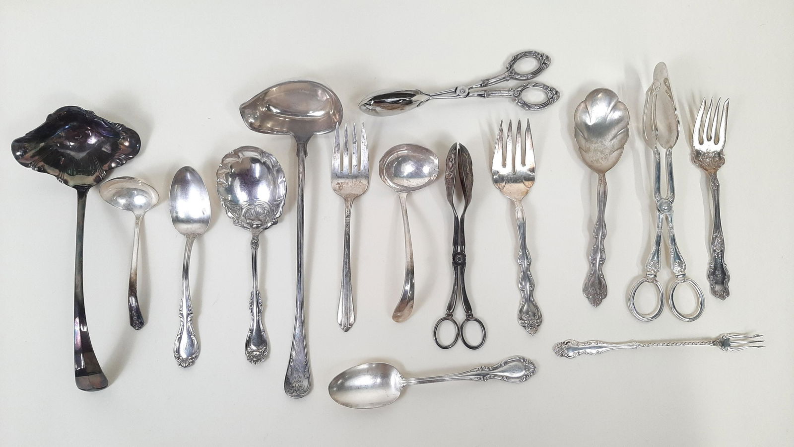 15 Serving Utensils incl. Silverplate: Also includes stainless. Includes Rogers, R. Wallace, and Holmes and Edwards. 7-1/2" to 13" long. IMPORTANT: Before bidding, please read the terms and conditions. When you registered for the auction y