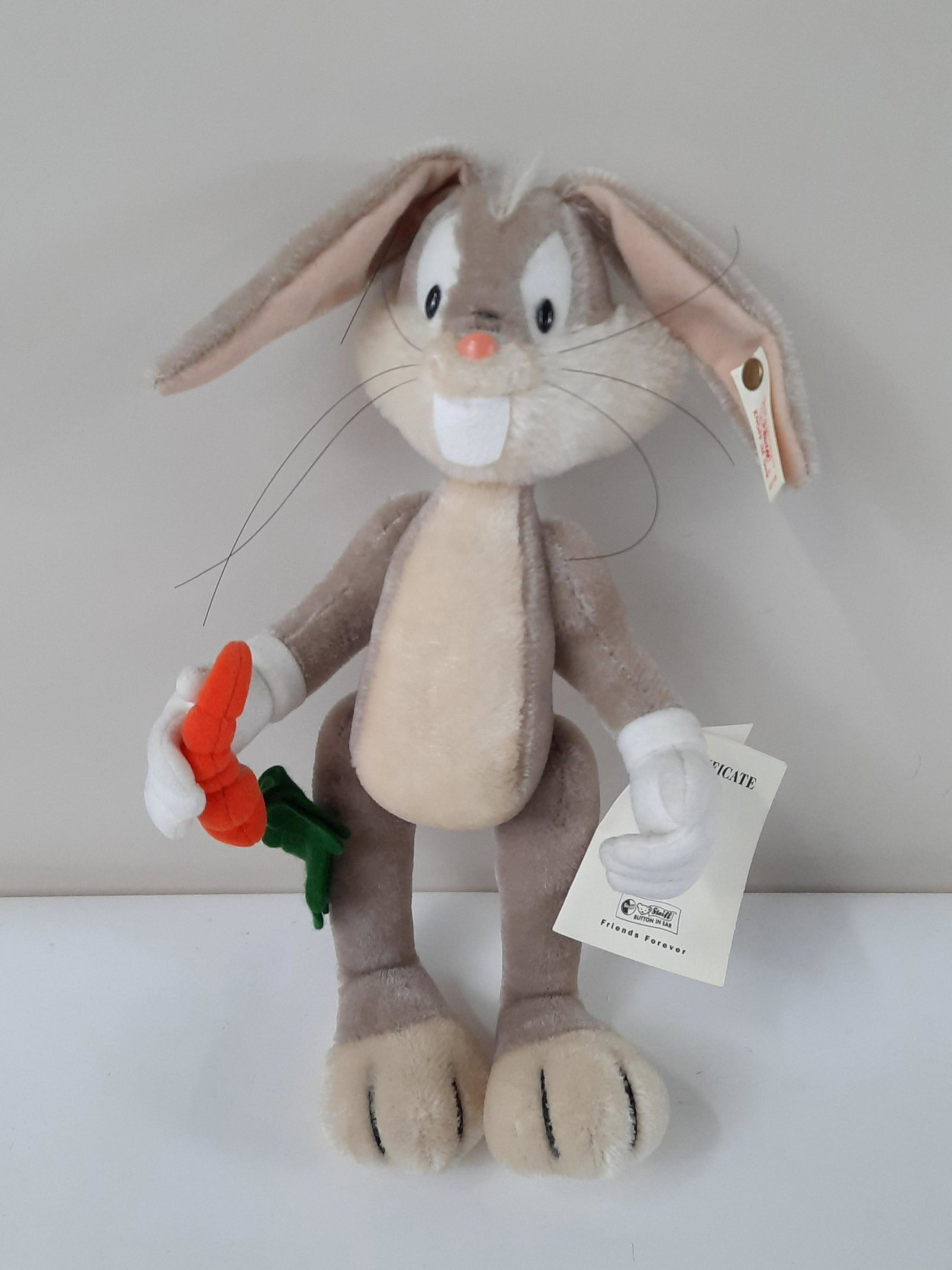 Limited Edition Steiff Bugs Bunny Doll: Pin tag on ear number 02000. Certificate attached to hand. Original bag included. 7" wide x 13" high. IMPORTANT: Before bidding, please read the terms and conditions. When you registered for the aucti