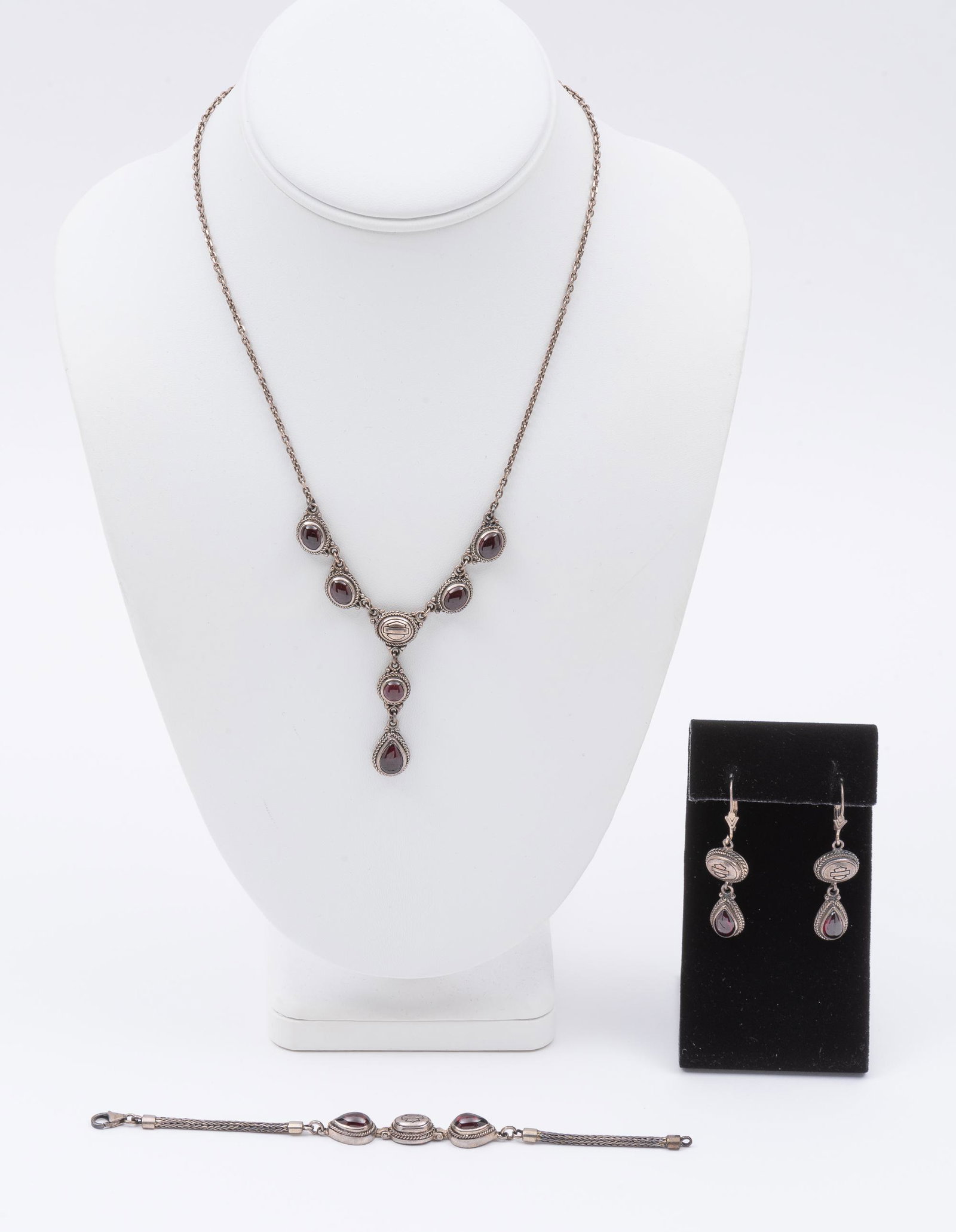 3 Pcs Sterling and Garnet Harley Davidson Jewlery: 6" bracelet, 17" necklace, 1-1/2" earrings. IMPORTANT: Before bidding, please read the terms and conditions. When you registered for the auction you agreed to these terms and will be required to compl