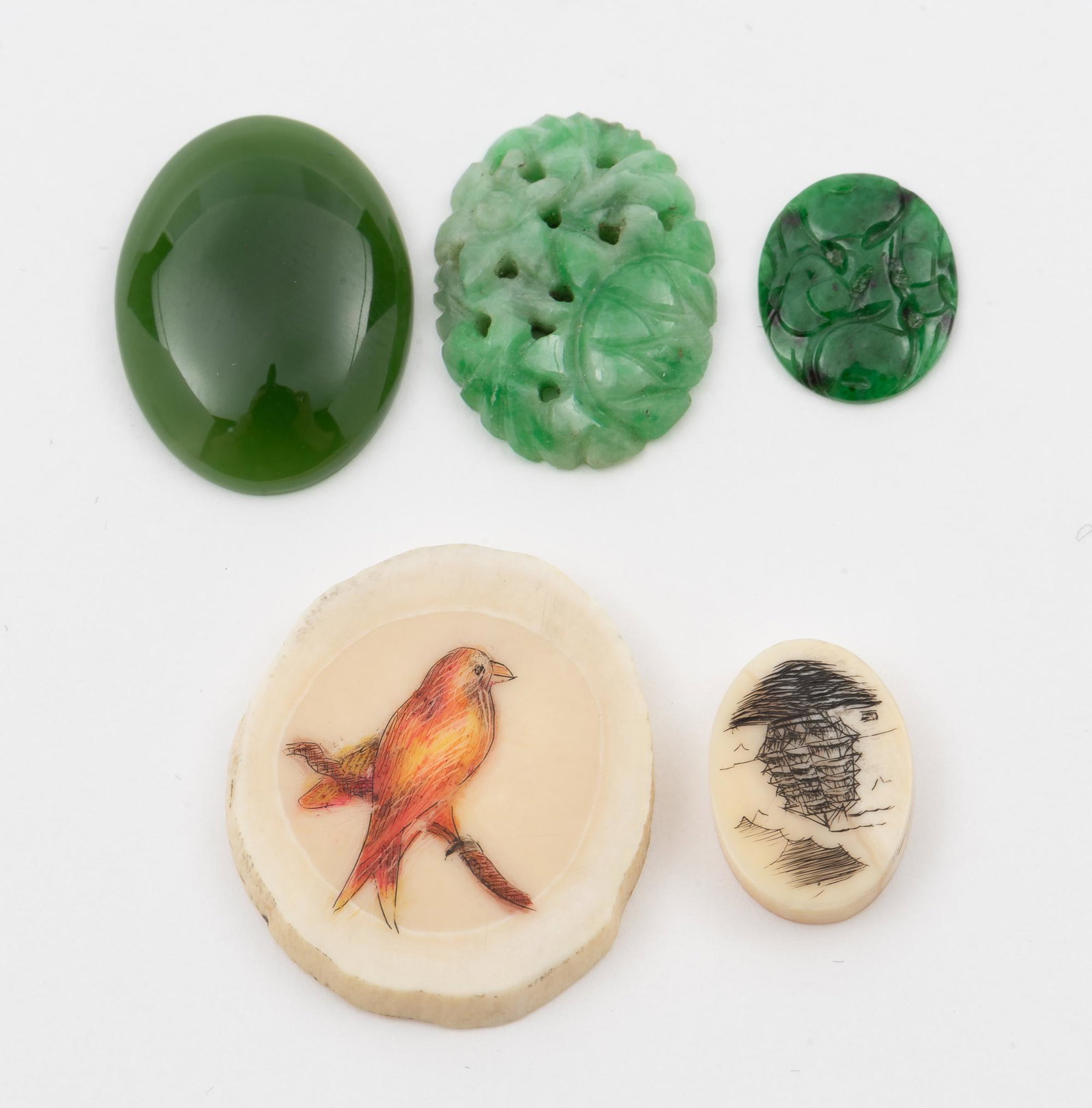 Jade & Scrimshaw: Two scrimshaw, ½" and 1". Nephrite cabochon, ¾", 2 carved jade cabochons. IMPORTANT: Before bidding, please read the terms and conditions. When you registered for the auction you agreed to these ter