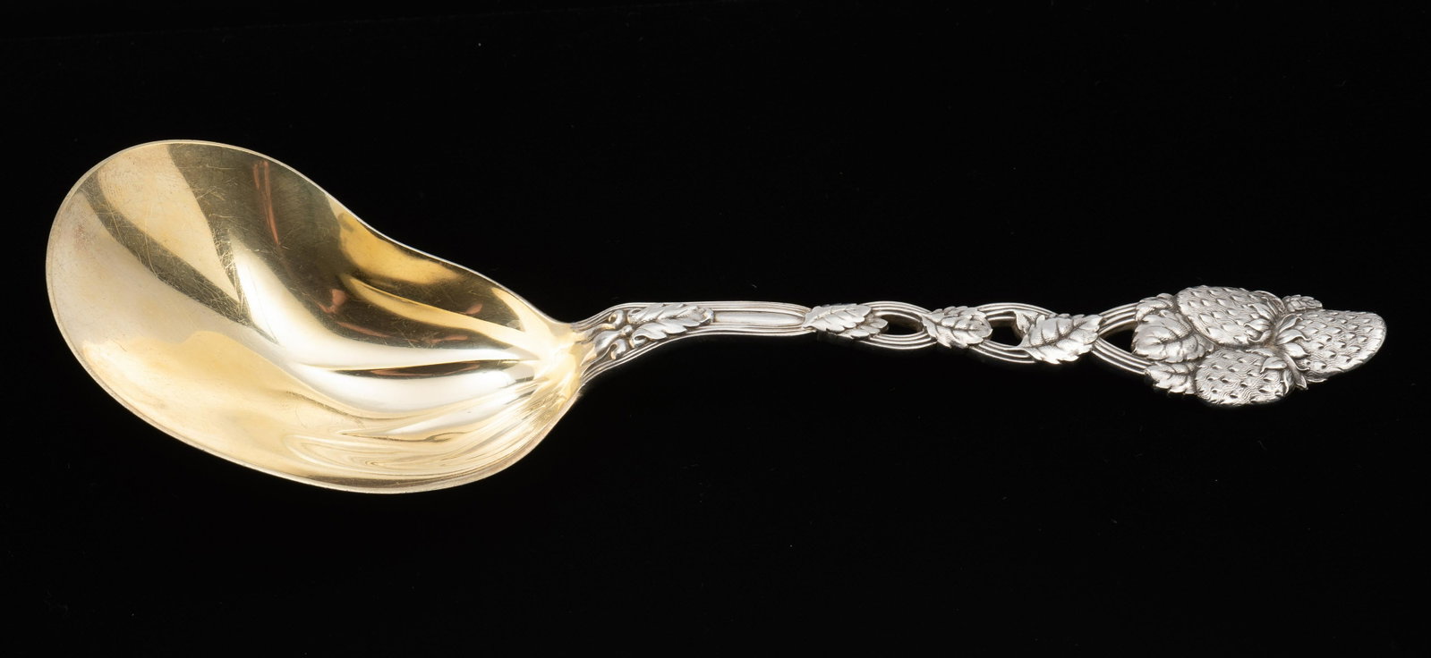 Tiffany Strawberry Sterling Berry Casserole Spoon: Strawberry pattern. Kidney shaped bowl. 9-1/2" long. 4.2 ozt. IMPORTANT: Before bidding, please read the terms and conditions. When you registered for the auction you agreed to these terms and will be