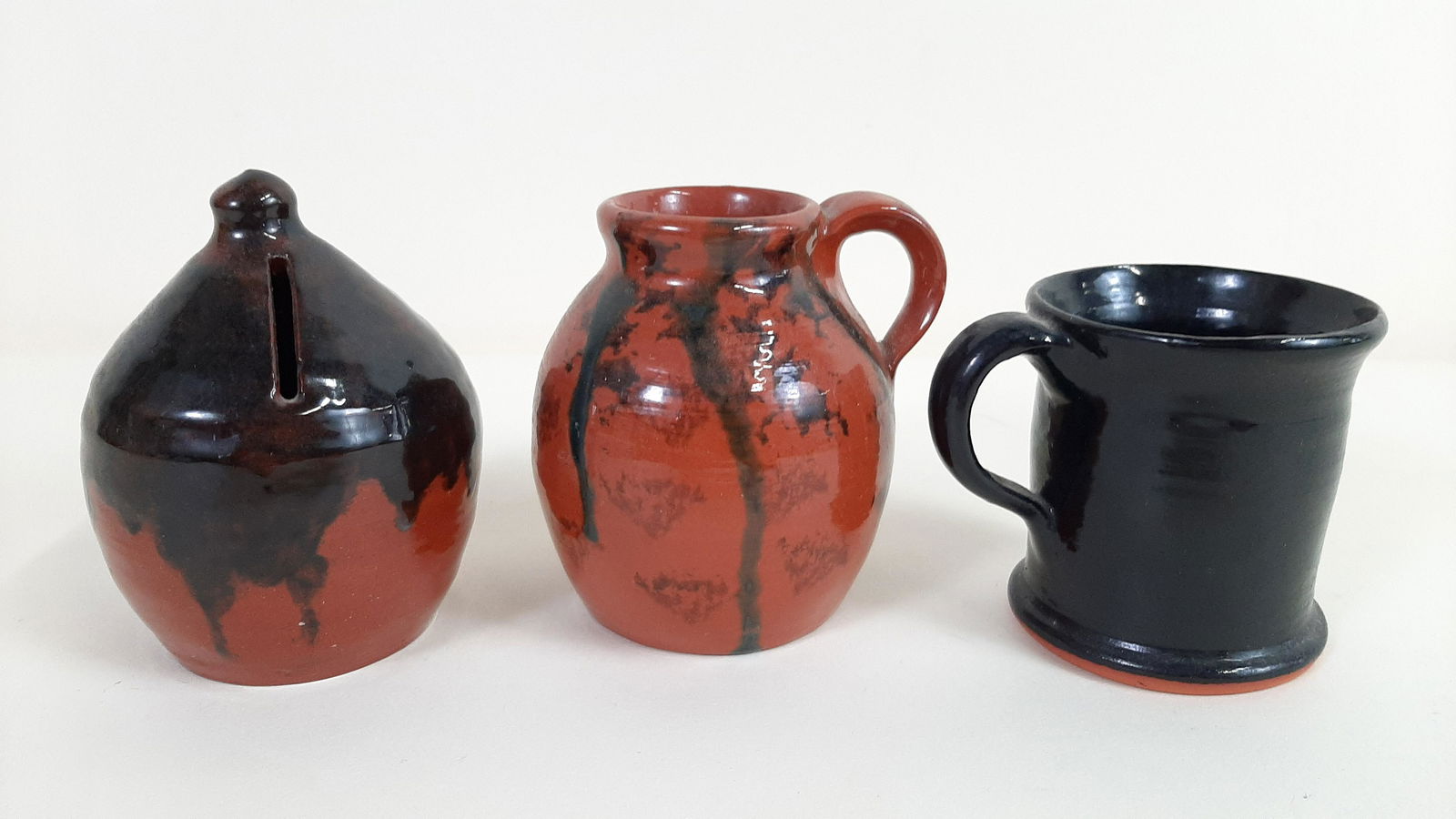 3 Don Winer Redware Miniatures: 20th C. potter. 2-1/2" to 3" diameter X 2-1/2" to 3-1/2" high. IMPORTANT: Before bidding, please read the terms and conditions. When you registered for the auction you agreed to these terms and will b