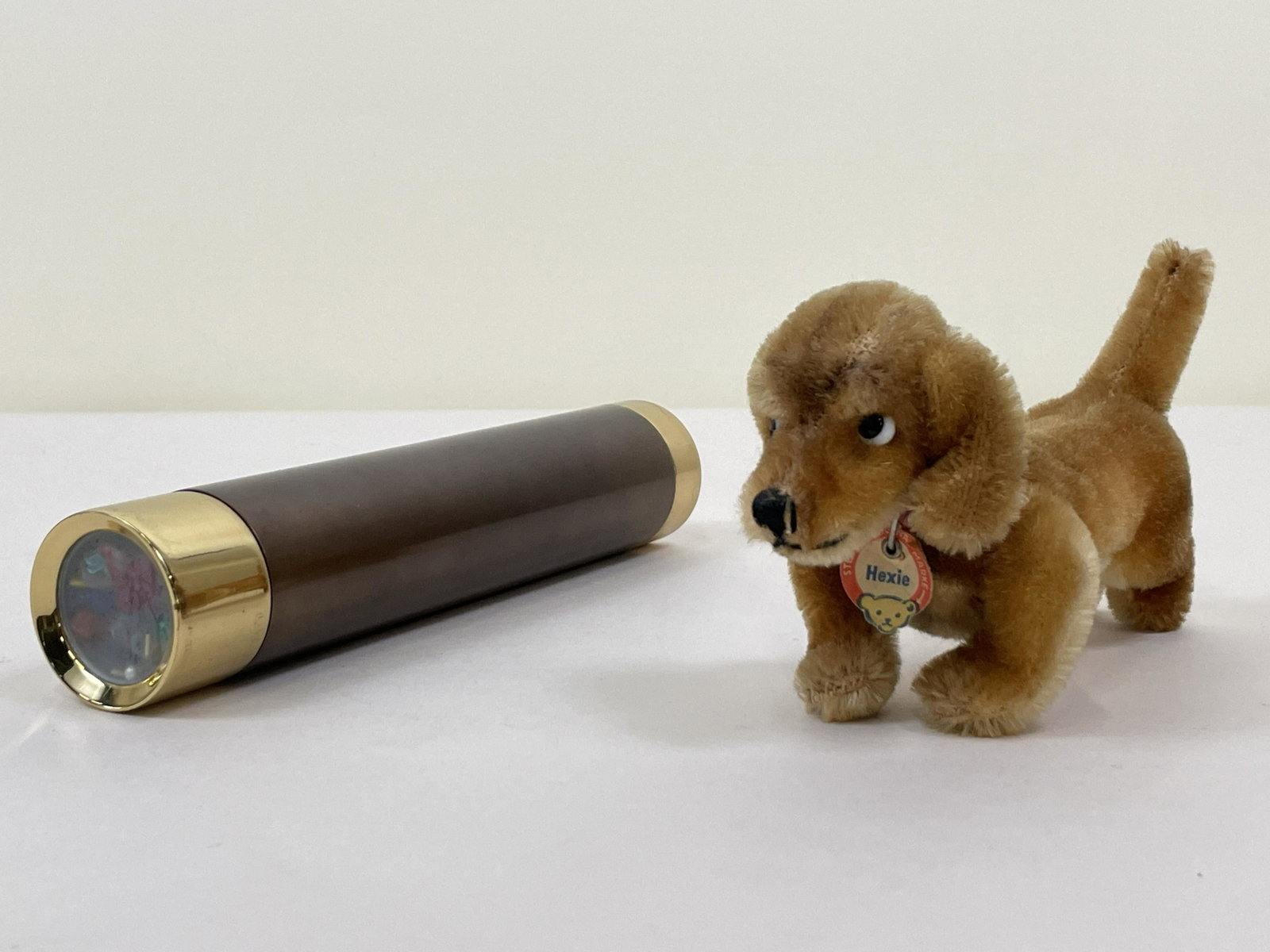 Steiff Dog and Kaleidoscope: Dog named Hexie. Tag on collar. 2 /12" wide x 5 1/2" deep x 3 1/2" high. IMPORTANT: Before bidding, please read the terms and conditions. When you registered for the auction you agreed to these terms 