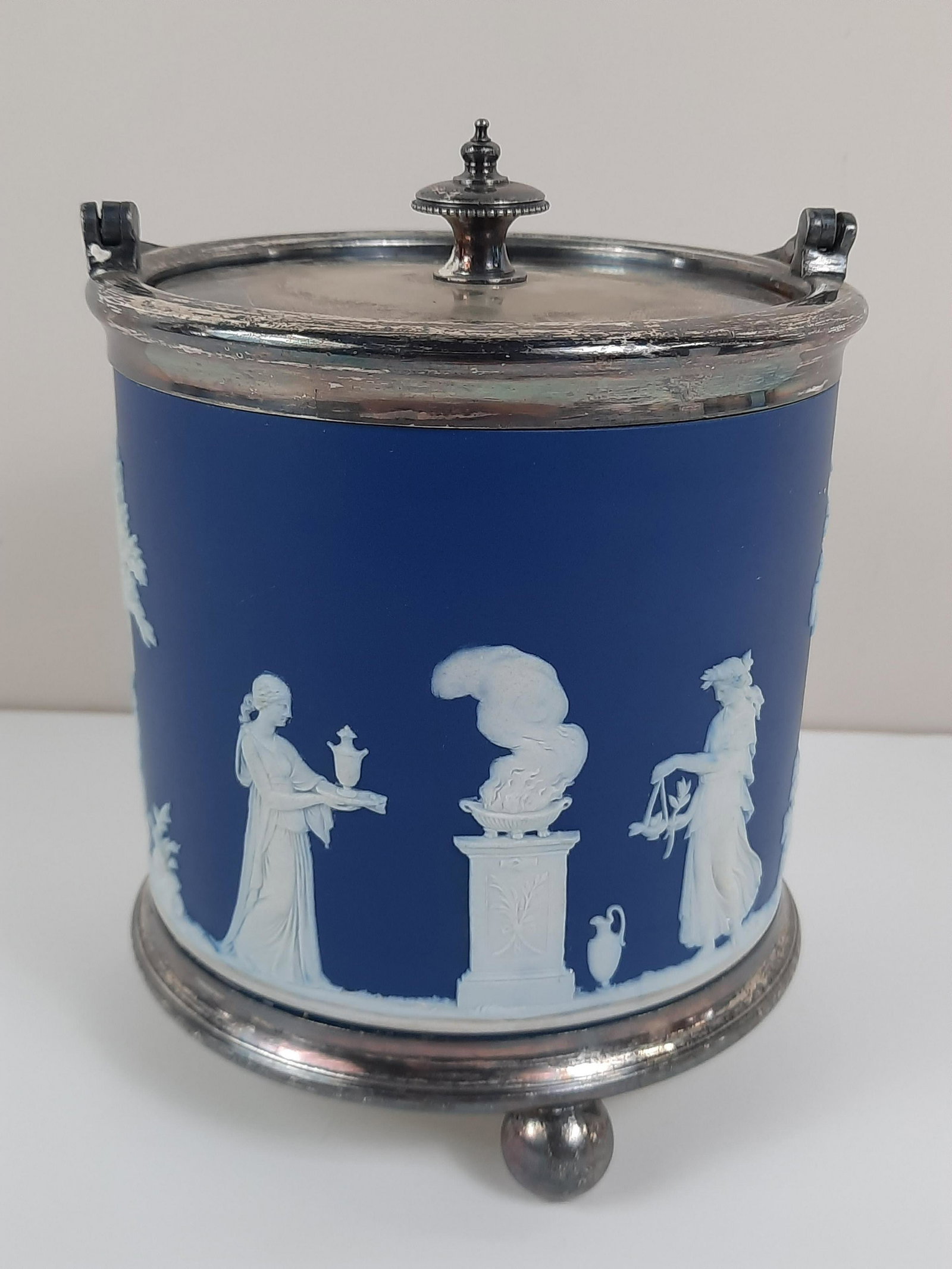 Wedgwood Biscuit Jar: 5-1/4" diameter x 7-1/4" high. IMPORTANT: Before bidding, please read the terms and conditions. When you registered for the auction you agreed to these terms and will be required to comply with them.
