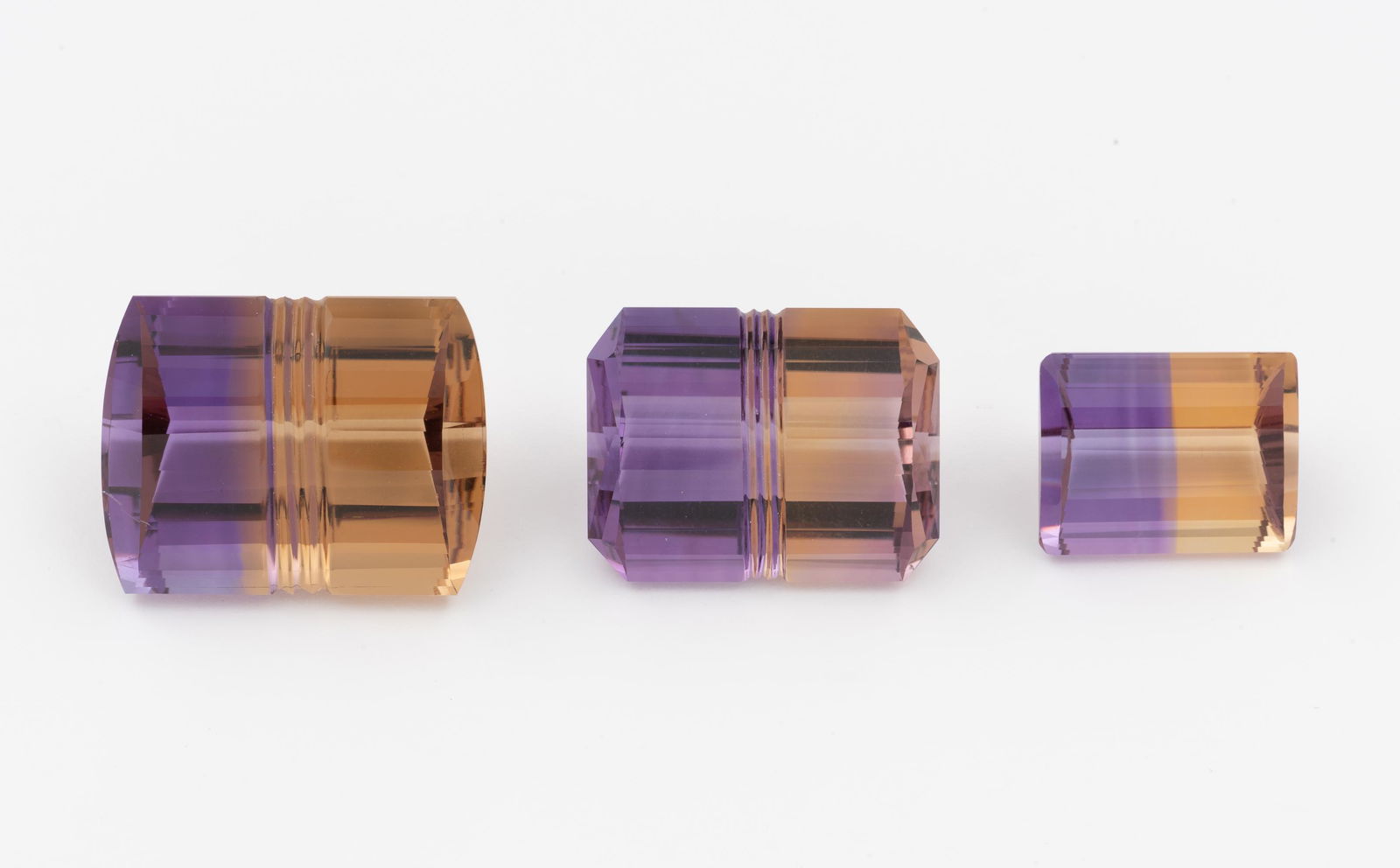 3 Fancy Cut Ametrine: DESCRIPTION: Three emerald fancy cut ametrine gemstones. MEASUREMENTS: Approximately 13 carats, 27 carats, and 35 carats. IMPORTANT: Before bidding, please read the terms and conditions. When you regi