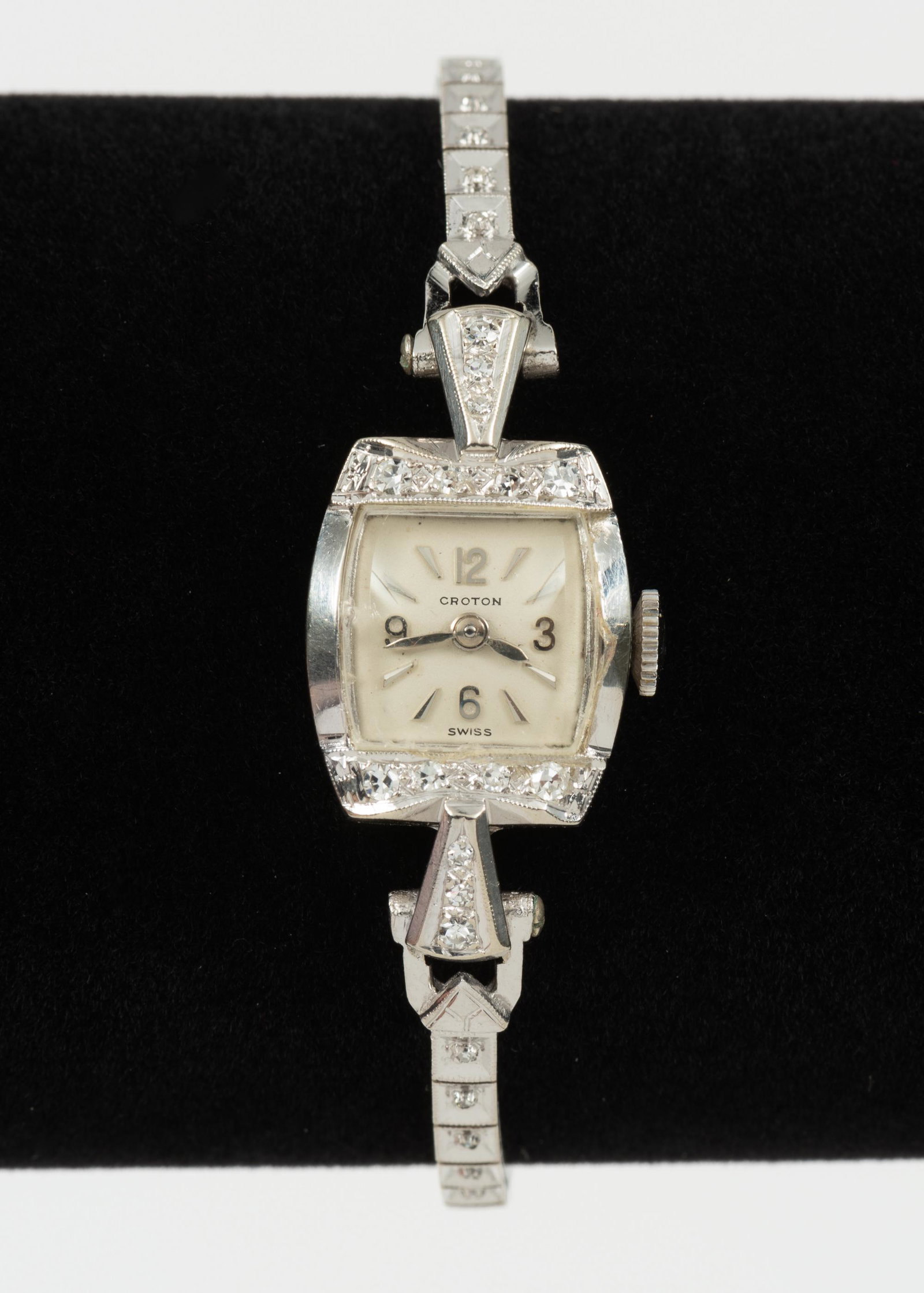 Croton 14K & Diamond Ladies Wristwatch: DESCRIPTION: 14k white gold case and band with approximately .64 CTW diamonds. 17 jewels. Safety chain. MEASUREMENTS: 6-1/2" long. 1-1/8" lug to lug. 7.7 dwt (12 gr) case, band and crystal weight only