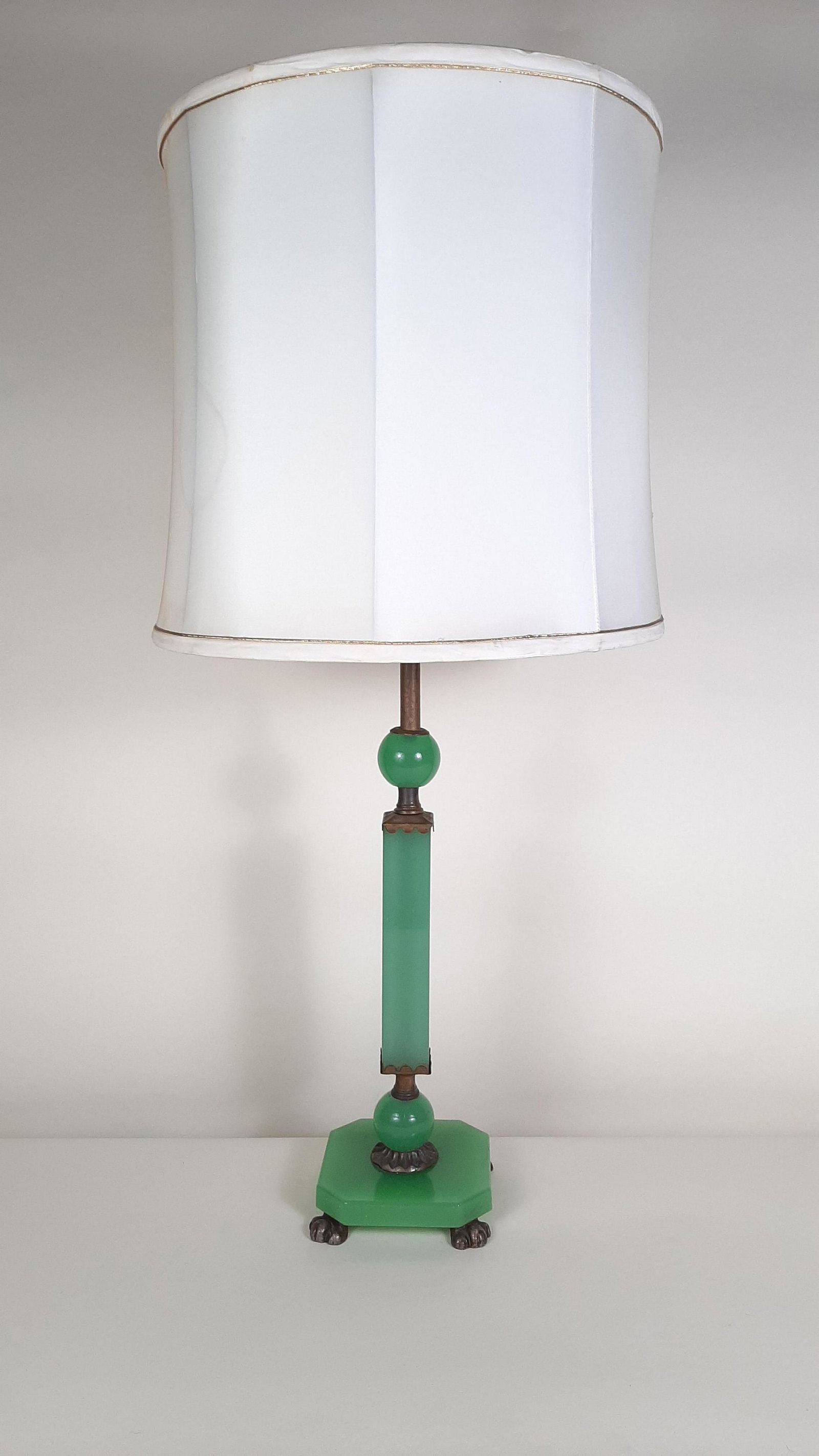 Green Glass Table Lamp: 32" high. Shade: 14-1/2" wide. IMPORTANT: Before bidding, please read the terms and conditions. When you registered for the auction you agreed to these terms and will be required to comply with them.
