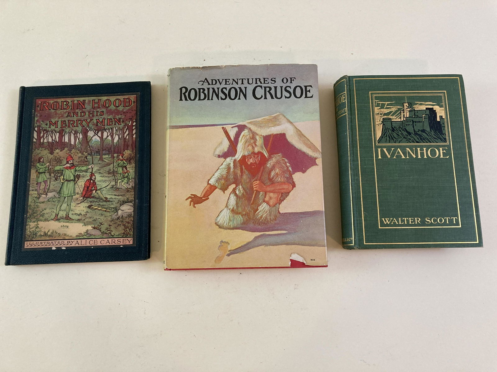 3 Adventure Books: Robin Hood and his Merry Men by Rosemary Kingston, Illustrated by Alice Carsey, 7“ wide x 9“ high. Adventures of Robin Crusoe by Daniel Defo, 7 1/2 “ wide x 10“ high. Ivanhoe by Sir Walter Sco