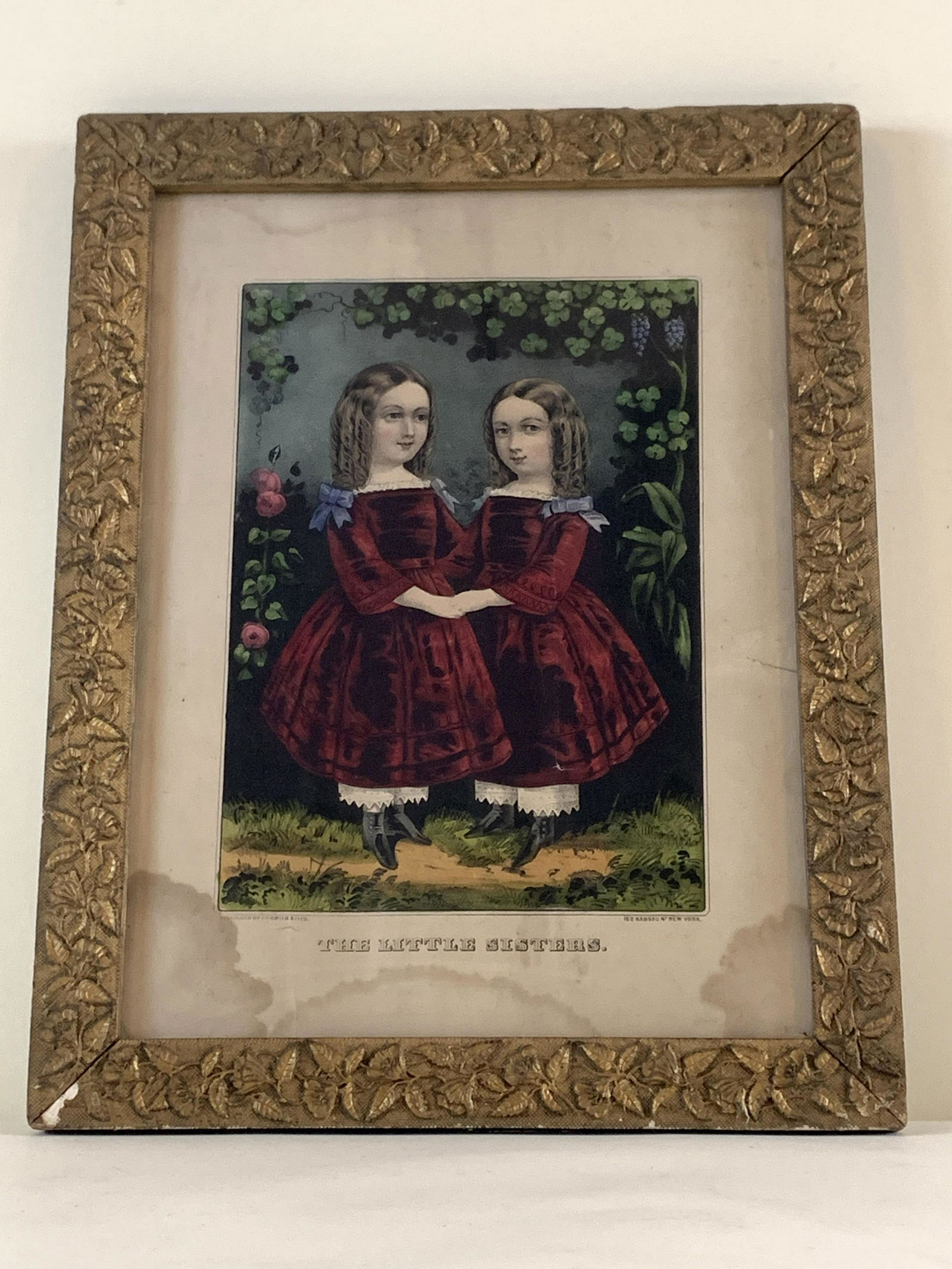 Currier & Ives “The Little Sisters” Print.: Water damage to bottom, does not enter print. Tear to edge, does not enter print. Areas of creasing. Loss to frame. 14-1/2” wide x 18-1/2” high. IMPORTANT: Before bidding, please read the terms an