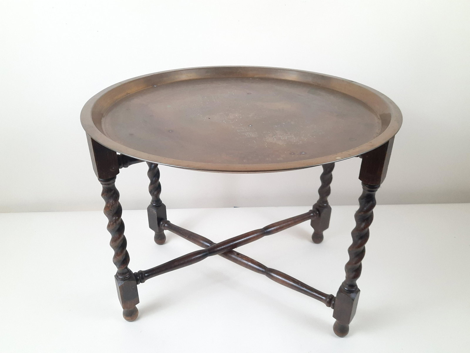 Brass Tray Table: 22" diameter x 17-1/2" high. Legs not screwed together. IMPORTANT: Before bidding, please read the terms and conditions. When you registered for the auction you agreed to these terms and will be requi