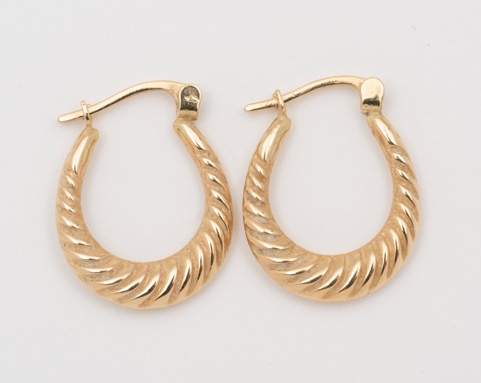 14K Hoop Earrings: 3/4" long. 0.8 dwt. IMPORTANT: Before bidding, please read the terms and conditions. When you registered for the auction you agreed to these terms and will be required to comply with them.