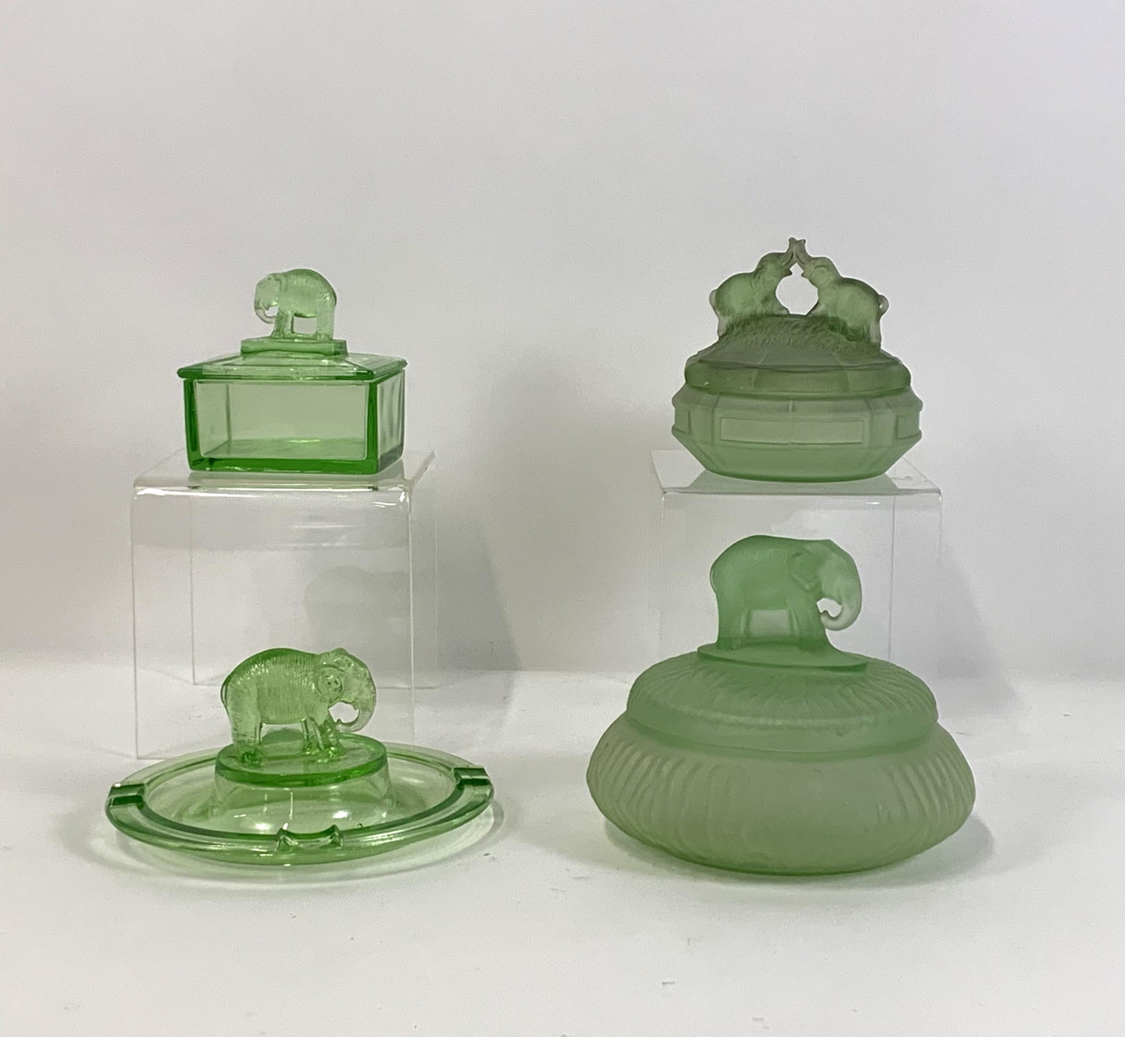 3 Green Glass Elephant Boxes and Ashtray: 3-1/2” high to 5” high. IMPORTANT: Before bidding, please read the terms and conditions. When you registered for the auction you agreed to these terms and will be required to comply with them.