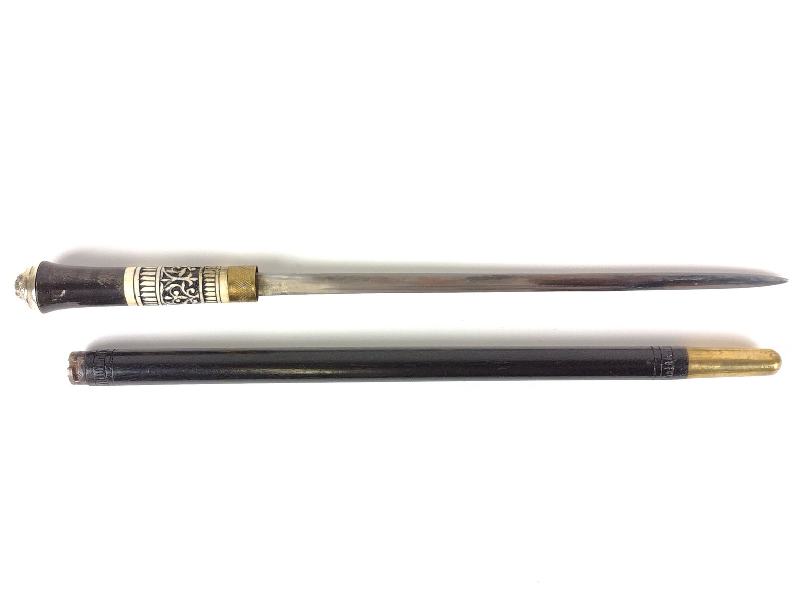 Indian Swagger Stick Sword: With bone inlay handle. Made In India etched into blade. Sword 30" long. 23-1/2" overall. IMPORTANT: Before bidding, please read the terms and conditions. When you registered for the auction you agree