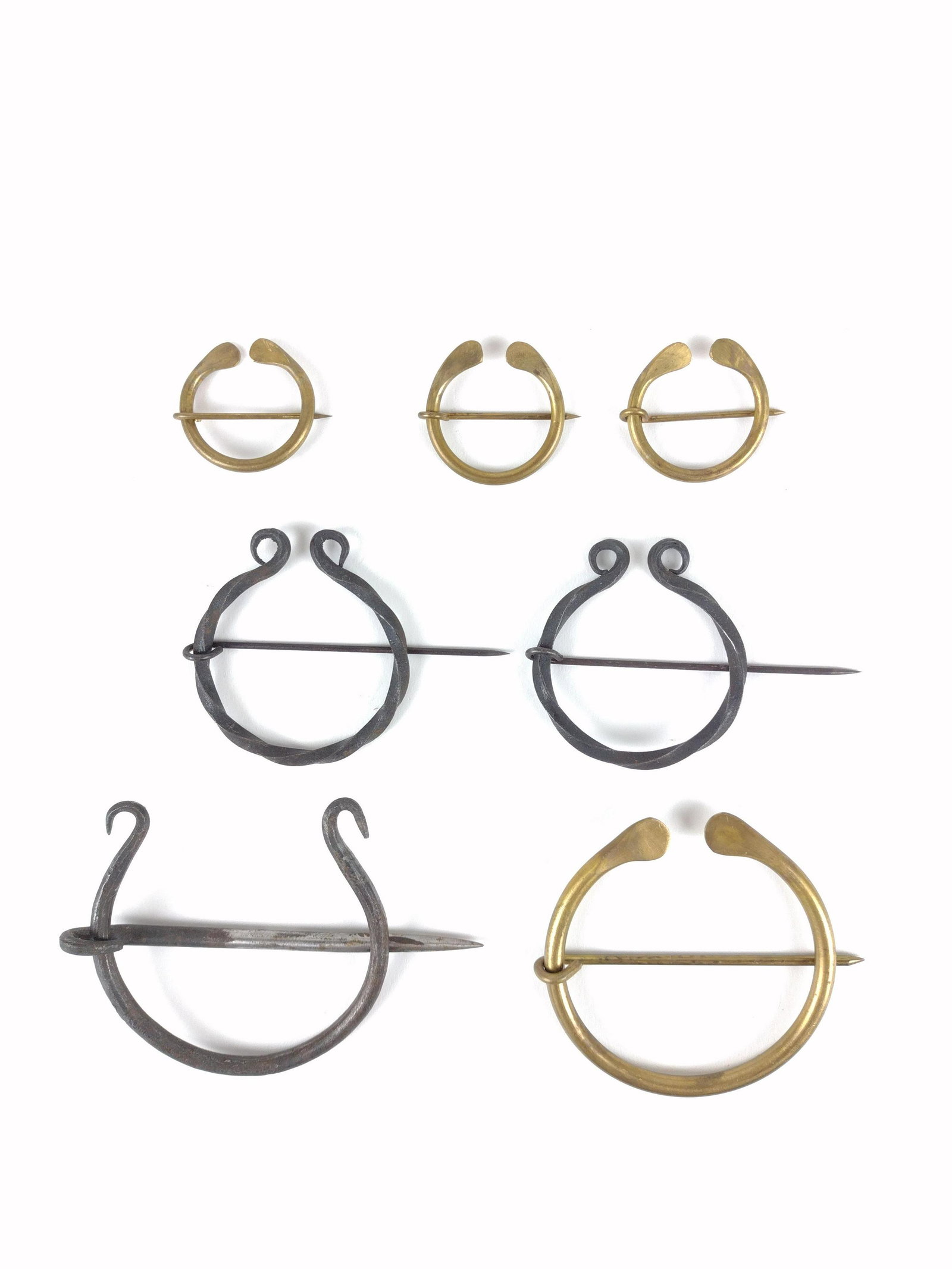 7 Pcs Hand Wrought Cloak Pins: 1-1/4" to 2-3/4" wide. IMPORTANT: Before bidding, please read the terms and conditions. When you registered for the auction you agreed to these terms and will be required to comply with them.