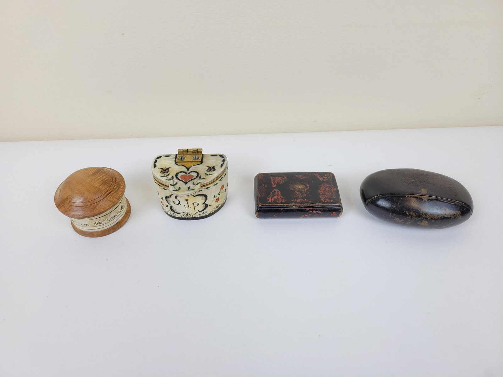 4 Snuff Boxes: Bone, leather, wood. 2"-3 1/4". IMPORTANT: Before bidding, please read the terms and conditions. When you registered for the auction you agreed to these terms and will be required to comply with them.