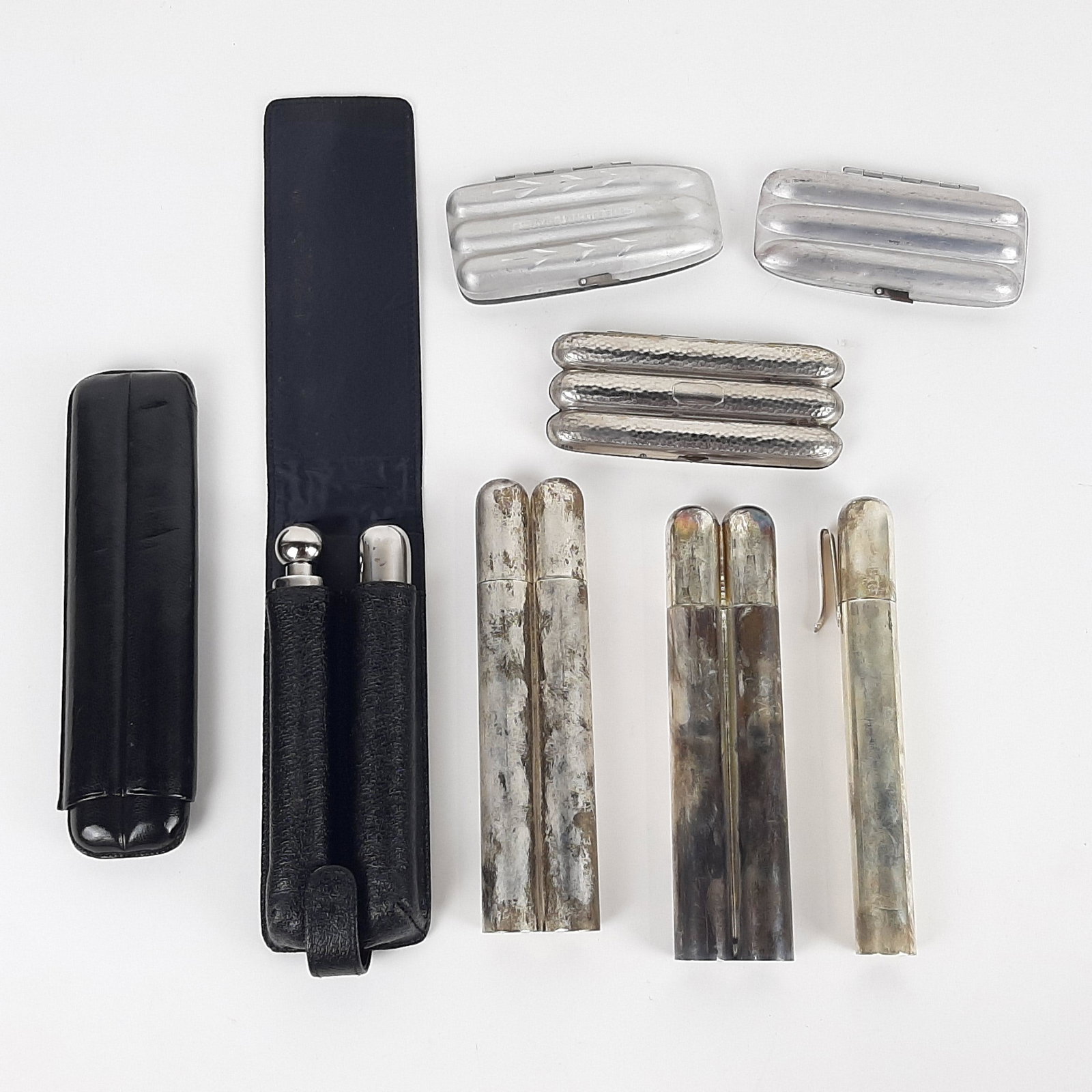 9 Cigar Holders incl. Chrome and Leather: Also includes cigar-shaped flask. 5-1/2" to 9" long.IMPORTANT: Before bidding, please read the terms and conditions. When you registered for the auction you agreed to these terms and will be required