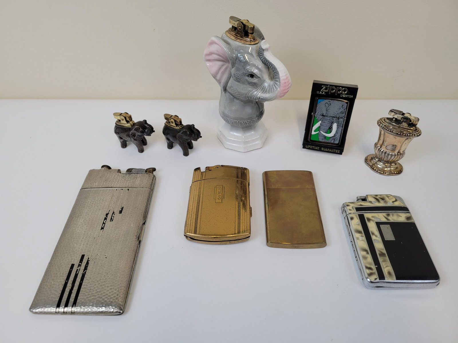 9 Lighters Incl Zippo & Ronson: Small 2 1/2" wide X 1" deep X 2" high. Large 4" wide X 2 1/4" deep X 6" high.IMPORTANT: Before bidding, please read the terms and conditions. When you registered for the auction you agreed to these te