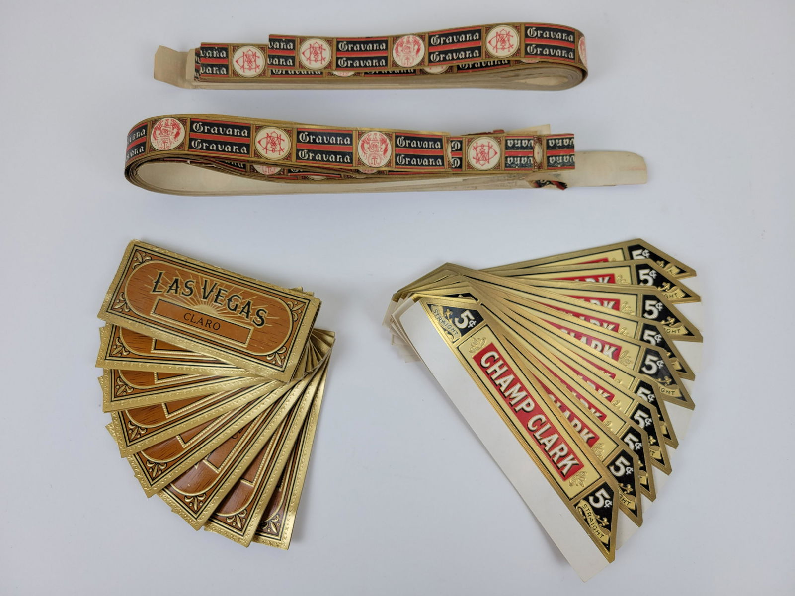 Grouping Of Cigar Bands: Champ Clark, Las Vagas Claro and Cravana.IMPORTANT: Before bidding, please read the terms and conditions. When you registered for the auction you agreed to these terms and will be required to comply w