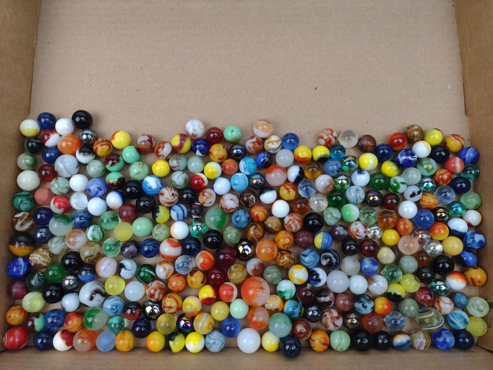309 Glass Marbles: Assorted colors and sizes. 1/2" to 1" diameter. IMPORTANT: Before bidding, please read the terms and conditions. When you registered for the auction you agreed to these terms and will be required to c