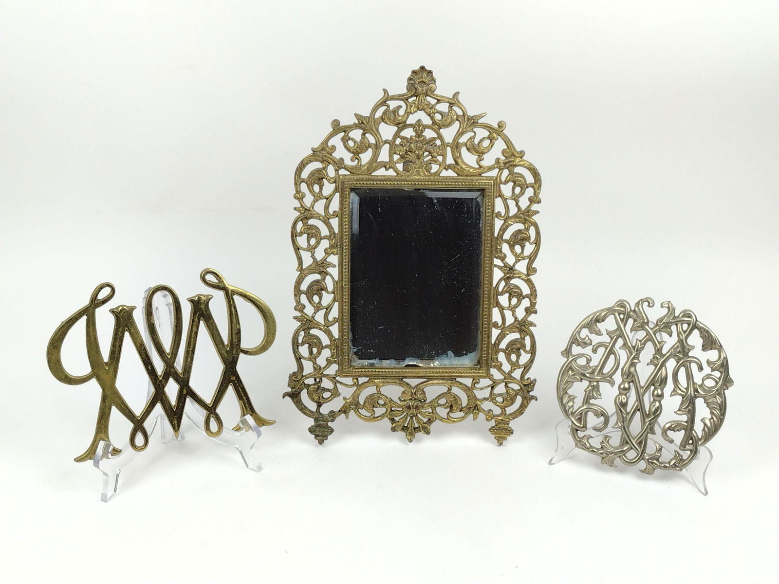 Frame & 2 Trivets: Trivets Colonial Williamsburg reproduction. Marked to bottom. Frame 13-1/2" high x 9" wide with 5"x 7" opening. Trivets 6" high x 6" to 8" wide. IMPORTANT: Before bidding, please read the terms and co