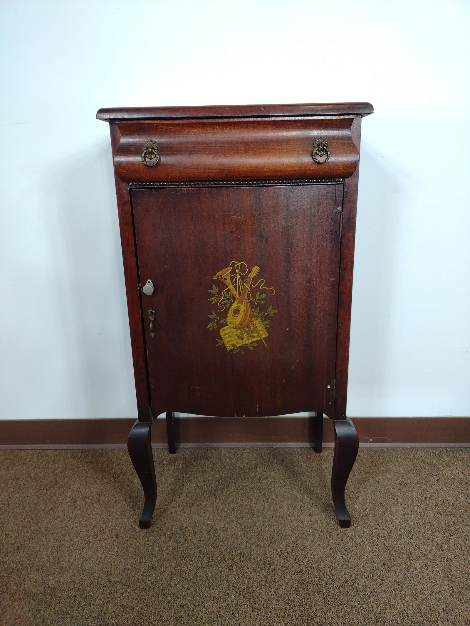 Inlaid Music Cabinet: 20" wide x 13-1/2" deep x 37" high. Loss to back. Crest missing. Some surface wear. IMPORTANT: Before bidding, please read the terms and conditions. When you registered for the auction you agreed to t