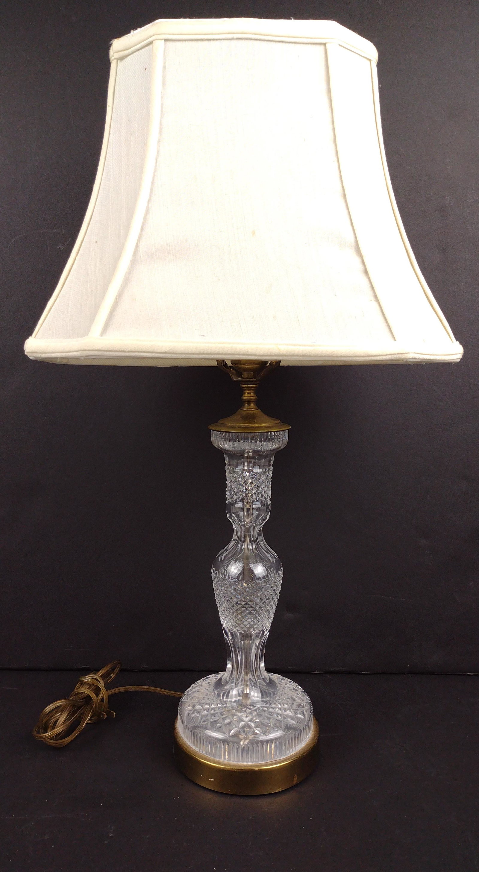 Clear Glass Lamp with Shade: Working. 26" high with finial. Shade 14-1/2" wide. Tear and staining to shade. IMPORTANT: Before bidding, please read the terms and conditions. When you registered for the auction you agreed to these 
