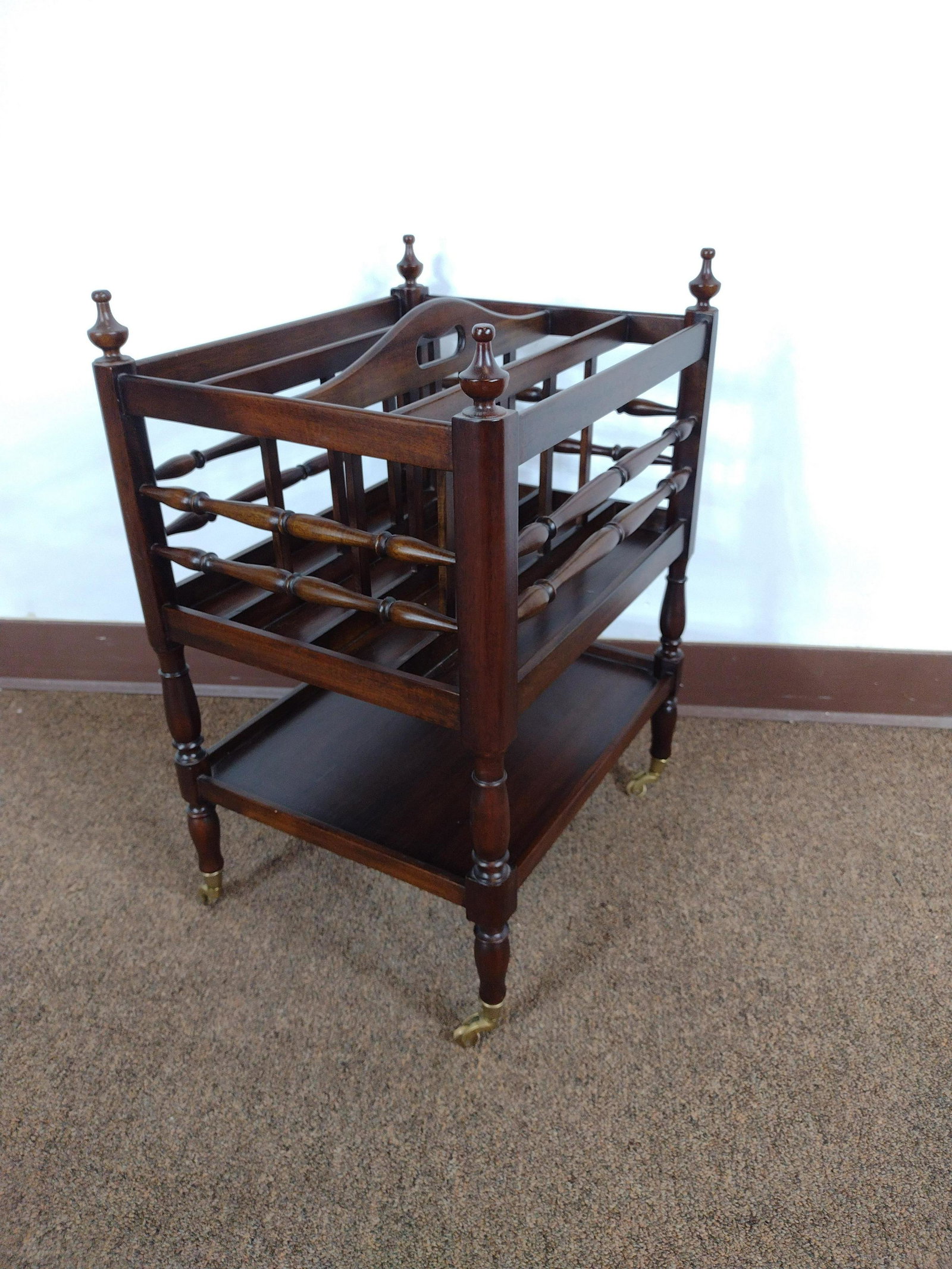 Wooden Magazine Rack with Casters: 15-1/2" wide x 13" deep x 22" high. IMPORTANT: Before bidding, please read the terms and conditions. When you registered for the auction you agreed to these terms and will be required to comply with t