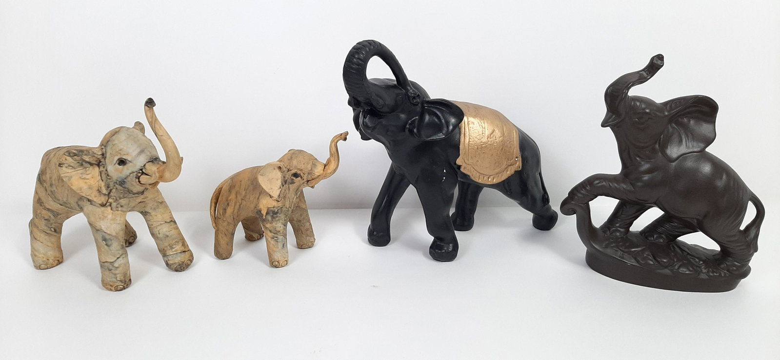 4 Elephant Sculptures incl. Ceramic: 7-1/2" to 12" long X 7" to 11-3/4" high. From the Estate of Stephen Pancoe, York Haven, PA. IMPORTANT: Before bidding, please read the terms and conditions. When you registered for the auction you agr