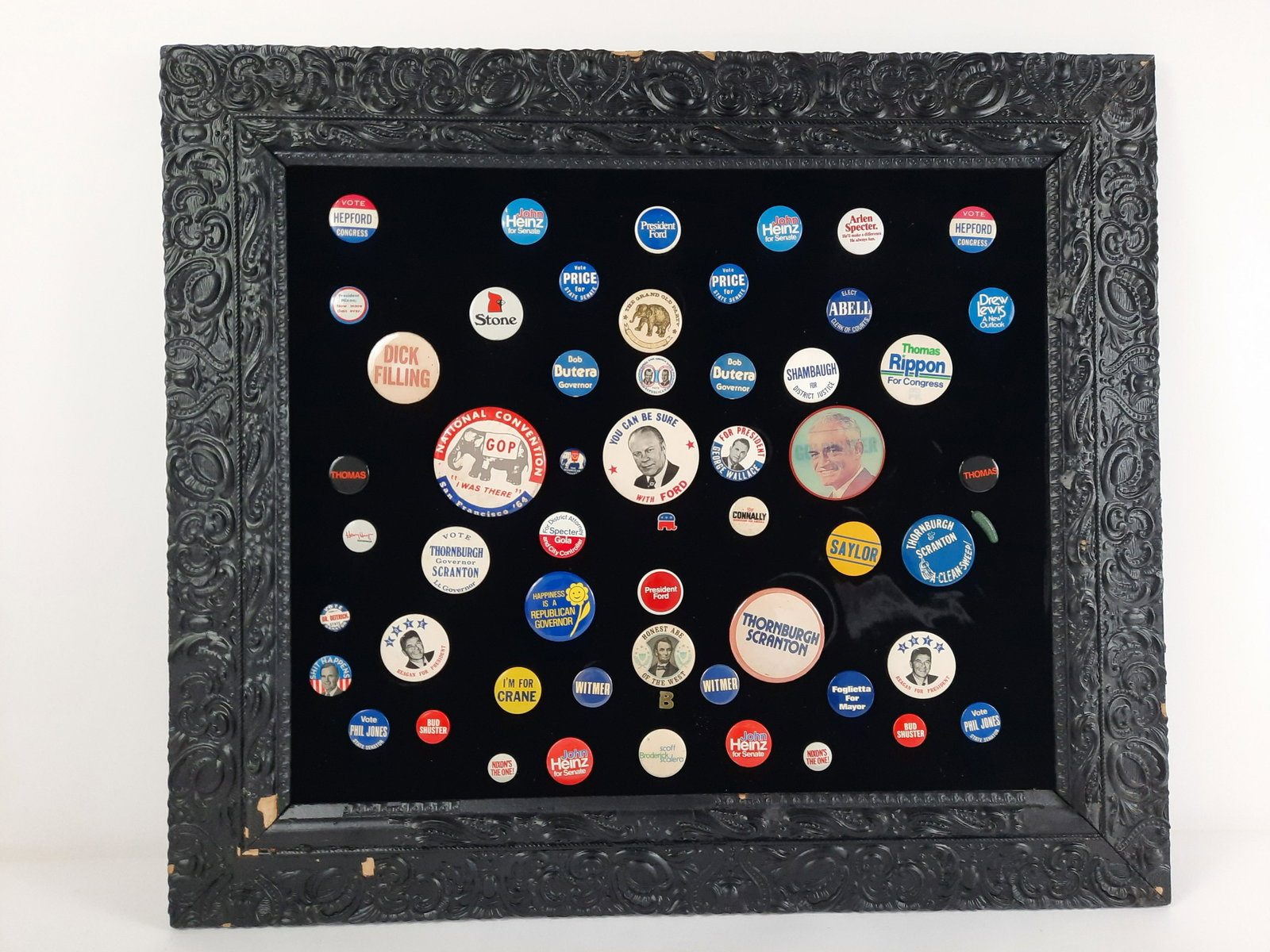 56 Political Pin Back Buttons incl Reagan: Overall with frame 26-1/2" high x 30-1/2" wide. Buttons: 3/4" to 3-1/2" diameter. From the Estate of Stephen Pancoe, York Haven, PA. IMPORTANT: Before bidding, please read the terms and conditions. Wh