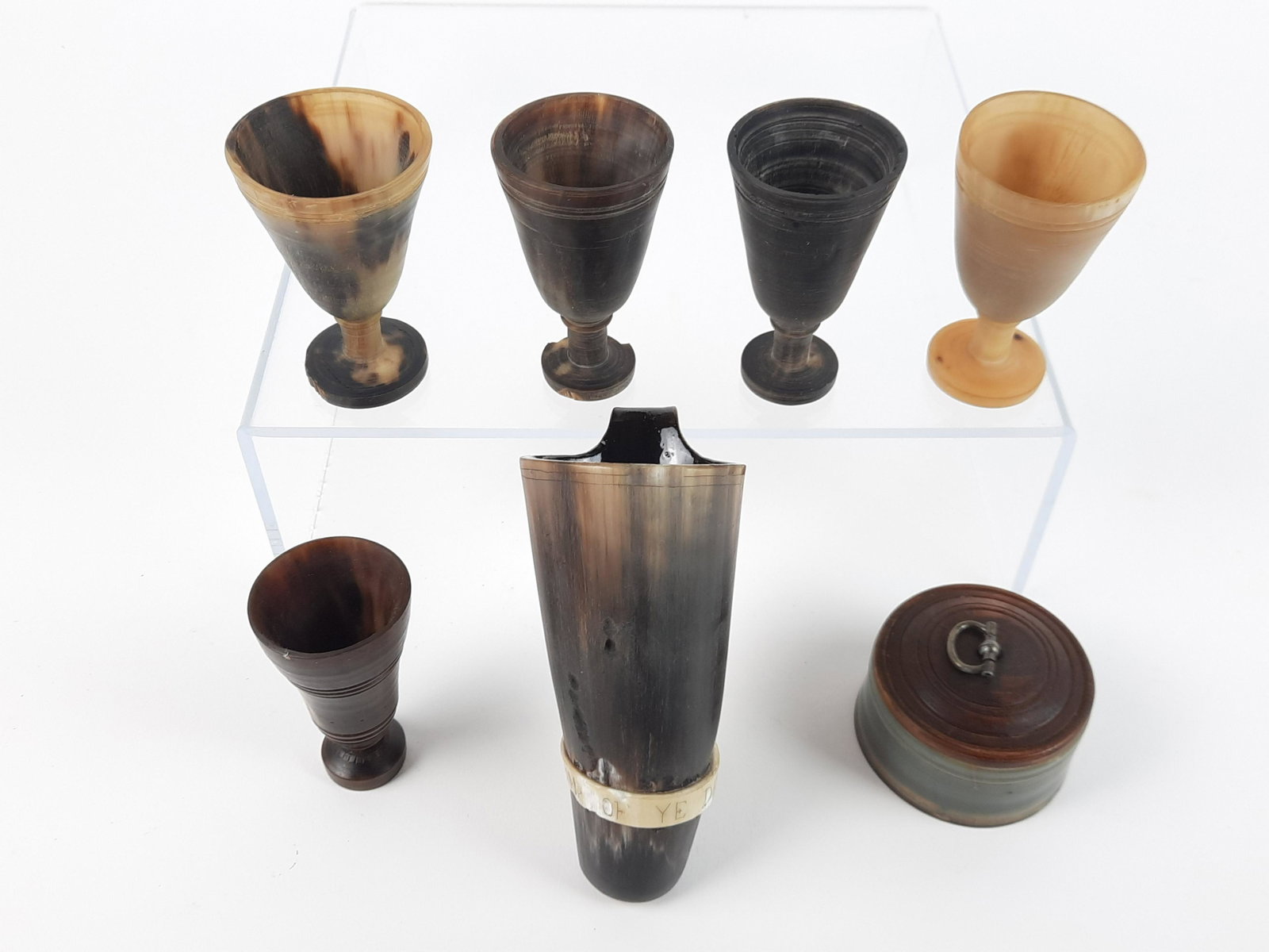 7 Bone Carvings incl Cups and Box: 1-1/2" to 5" high. Some losses to "Drink of Ye Devil" cup and one cup base. From the Estate of Stephen Pancoe, York Haven, PA. IMPORTANT: Before bidding, please read the terms and conditions. When you