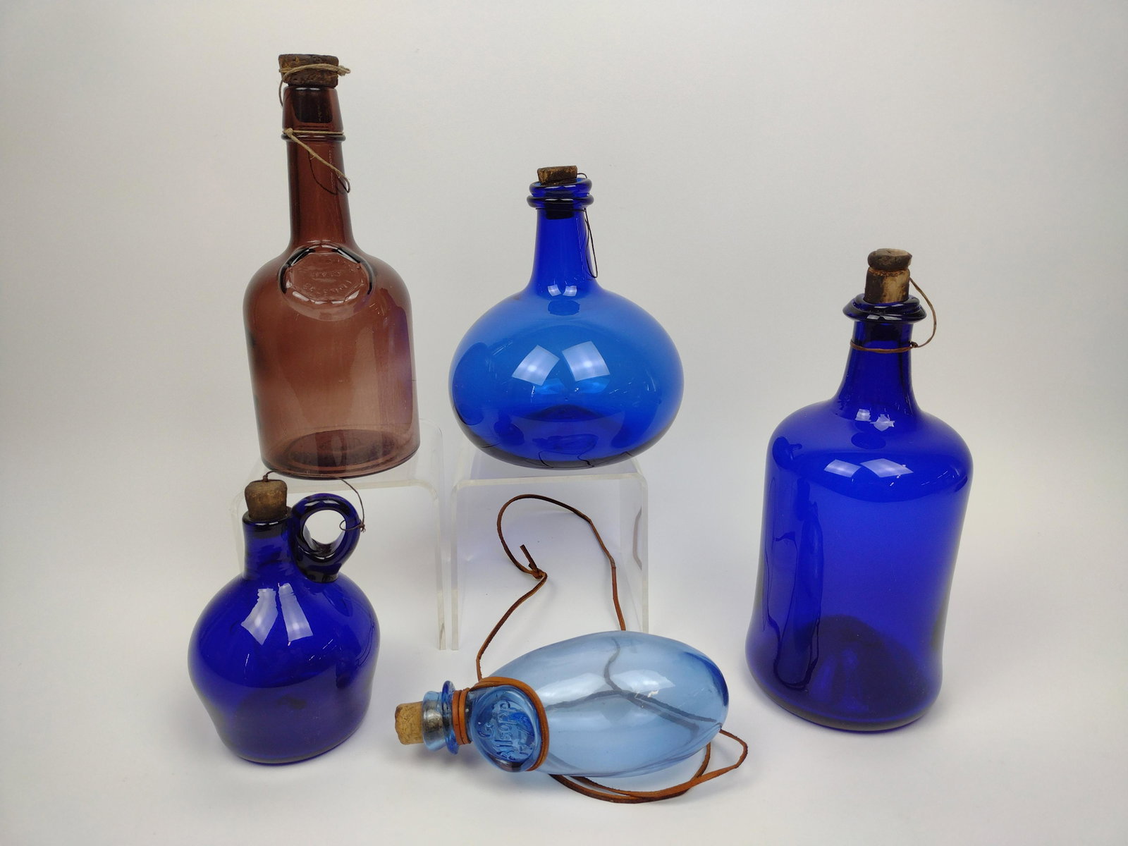 5 Glass Bottles incl Hand Blown: 3" to 6-1/2" diameter X 6" to 10" high. From the Estate of Stephen Pancoe, York Haven, PA. IMPORTANT: Before bidding, please read the terms and conditions. When you registered for the auction you agre