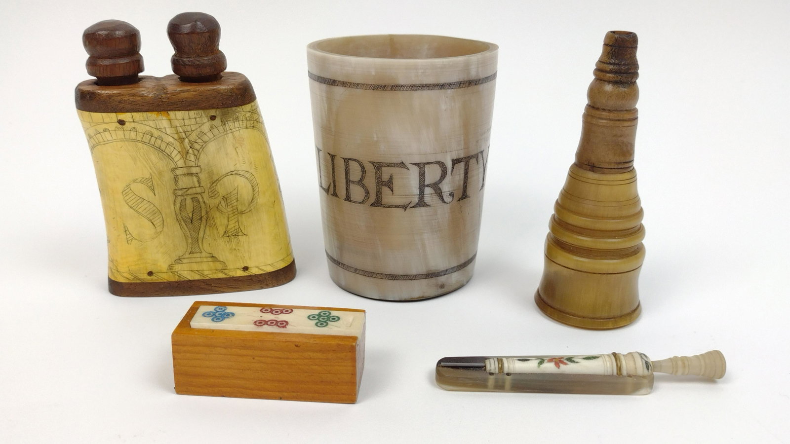 5 Pcs Carved Horn and Bone incl Miniature Dominos: Also includes salt and pepper and erotic folk art cup. Domino set: 2" wide X 3/4" high. Salt and pepper: 2-3/4" wide X 4" high. From the Estate of Stephen Pancoe, York Haven, PA. IMPORTANT: Before bid