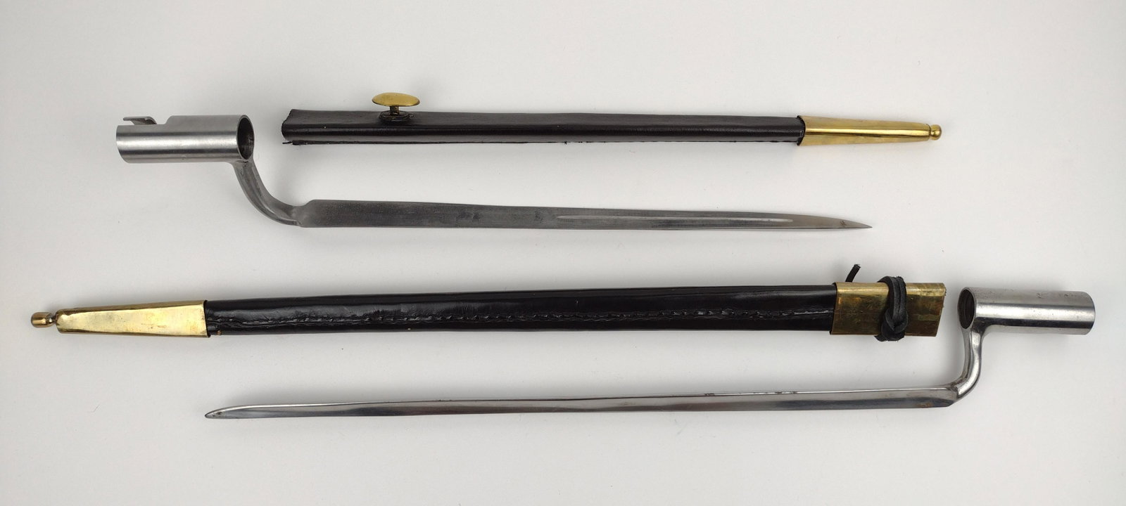 2 Bayonets: No markings. With brass and leather scabbards. 18-3/4" to 23-1/4" long. From the Estate of Stephen Pancoe, York Haven, PA. IMPORTANT: Before bidding, please read the terms and conditions. When you reg