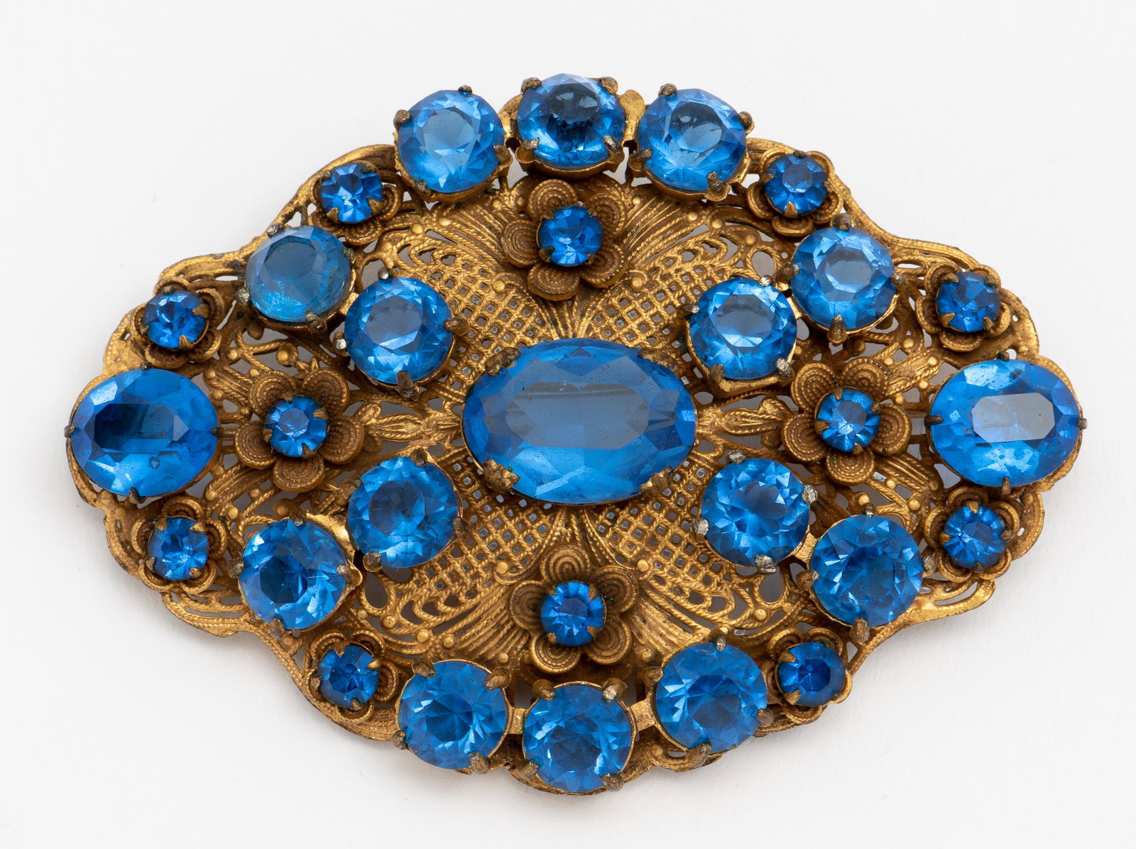 John Wanamaker Antique Brooch: Blue rhinestones. In original box. 3" wide x 2-1/4" high. IMPORTANT: Before bidding, please read the terms and conditions. When you registered for the auction you agreed to these terms and will be req