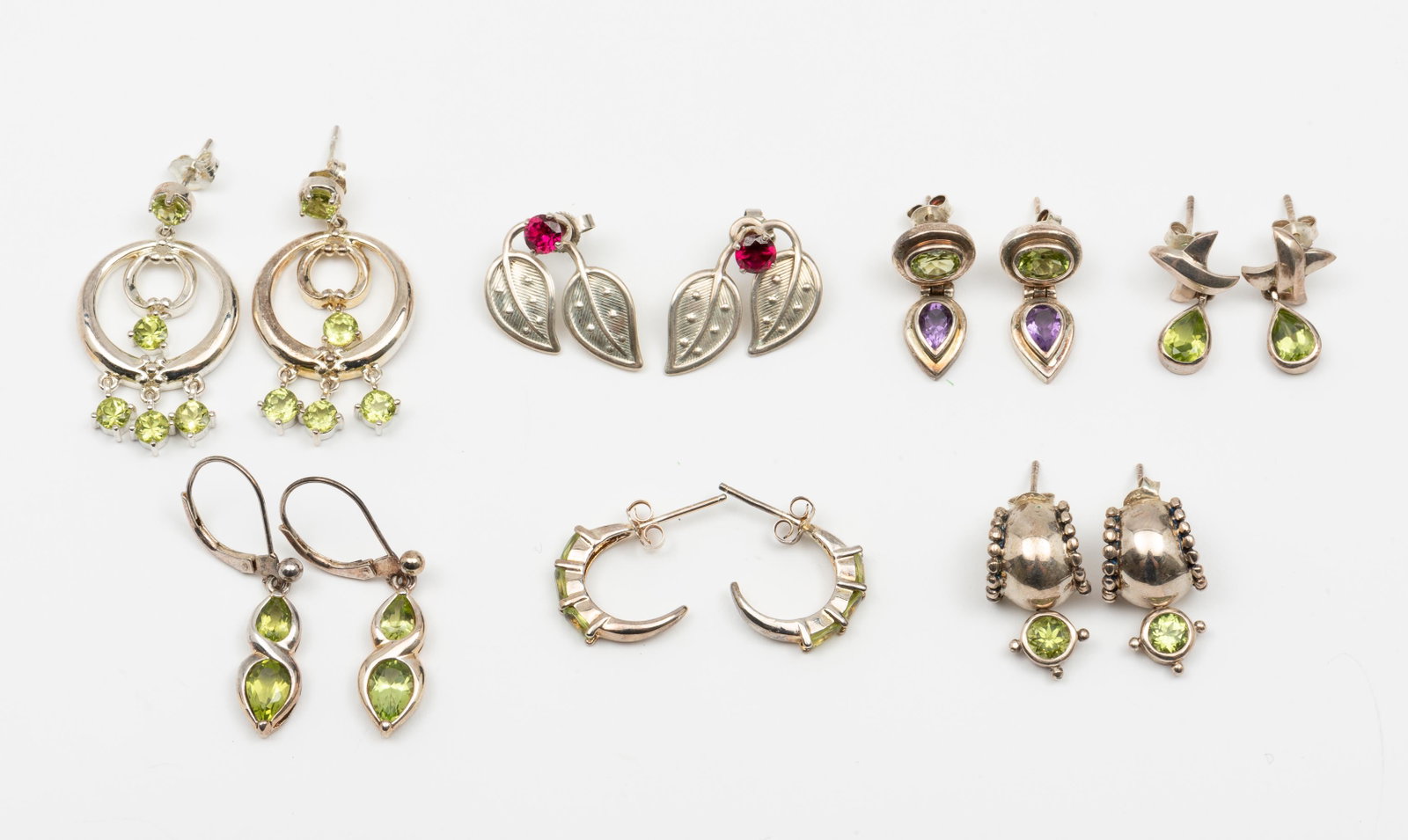 7 Pairs Sterling Earrings: With peridot and amethyst. 3/4" to 1-1/2" long. IMPORTANT: Before bidding, please read the terms and conditions. When you registered for the auction you agreed to these terms and will be required to c