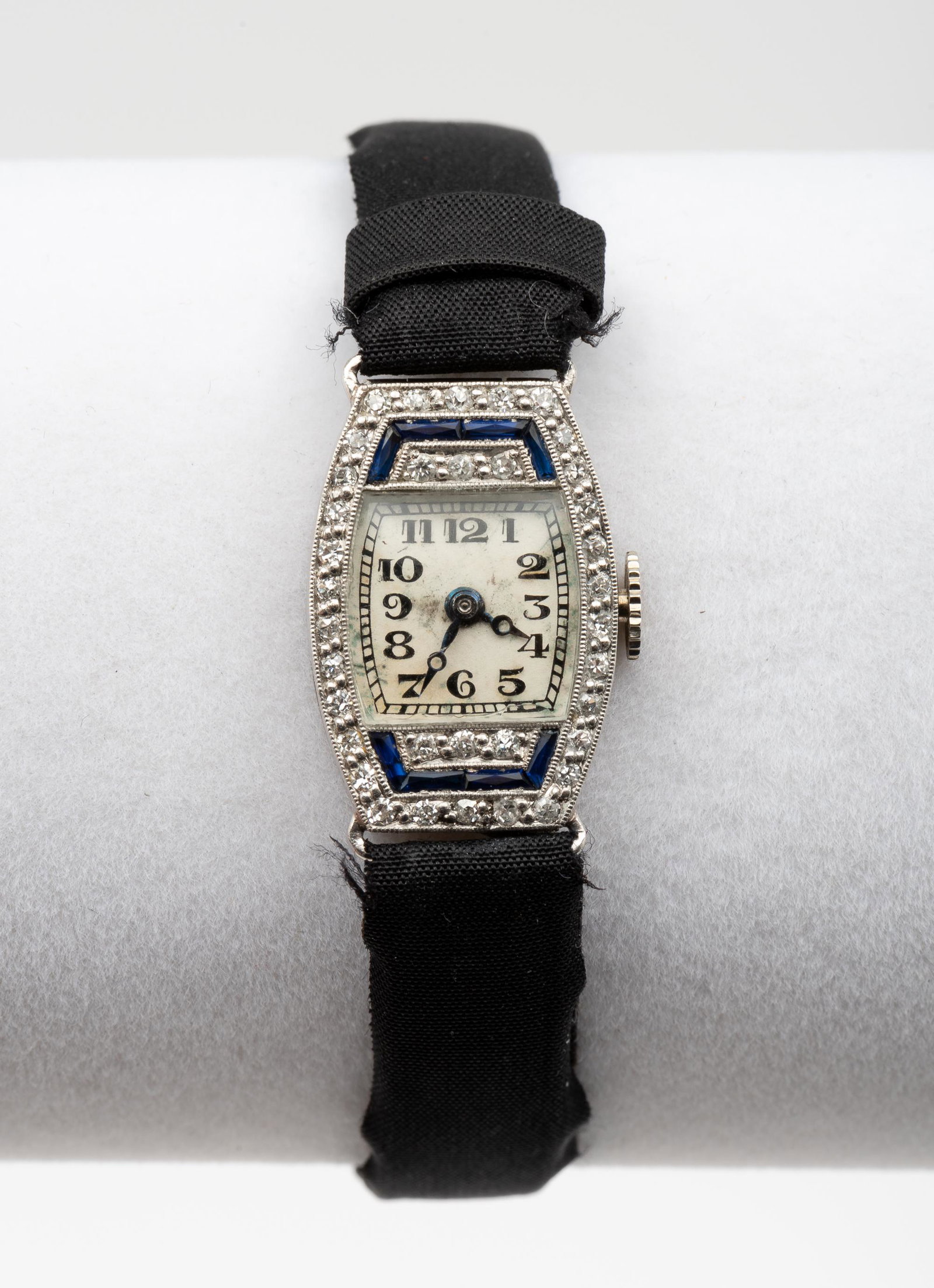 Platinum, Sapphire & .72 CTW Diamond Wristwatch: Art deco. Swiss platinum hallmark to case. Eight sapphires and thirty-six 2 point diamonds. Black satin and leather band. Running. 7" long overall. 15/16" lug to lug. IMPORTANT: Before bidding, please