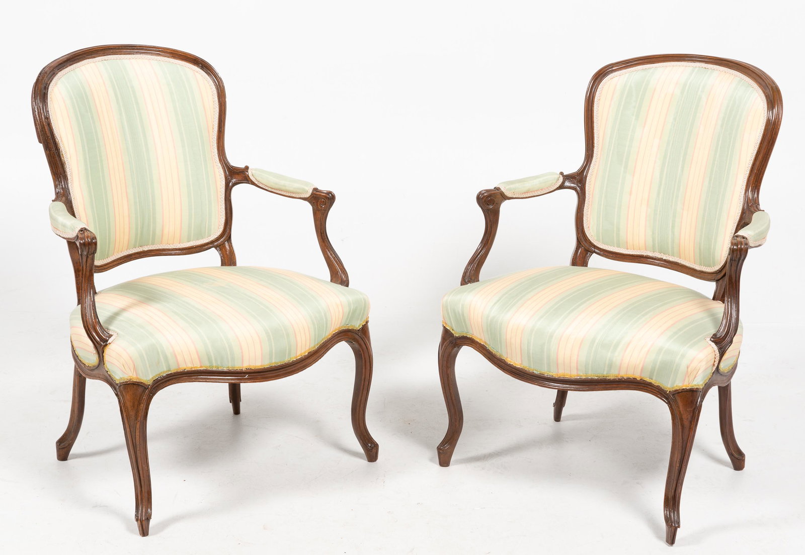 Pair of French Upholstered Arm Chairs: Fraying to the bottom of the upholstery, stain to seat of one chair. 35-1/2" high x 24-3/4" wide x 21" deep. IMPORTANT: Before bidding, please read the terms and conditions. When you registered for th