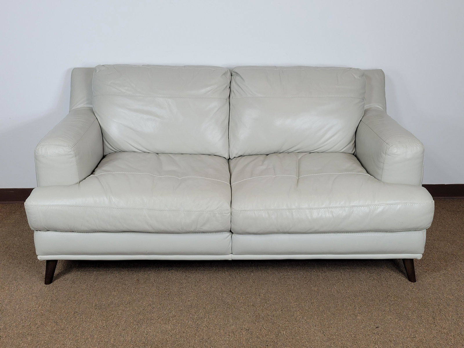 Leather Loveseat: 72" wide X 37 1/2" deep X 34" high. Leather with wear to arms and corners. MG IMPORTANT: Before bidding, please read the terms and conditions. When you registered for the auction you agreed to these t
