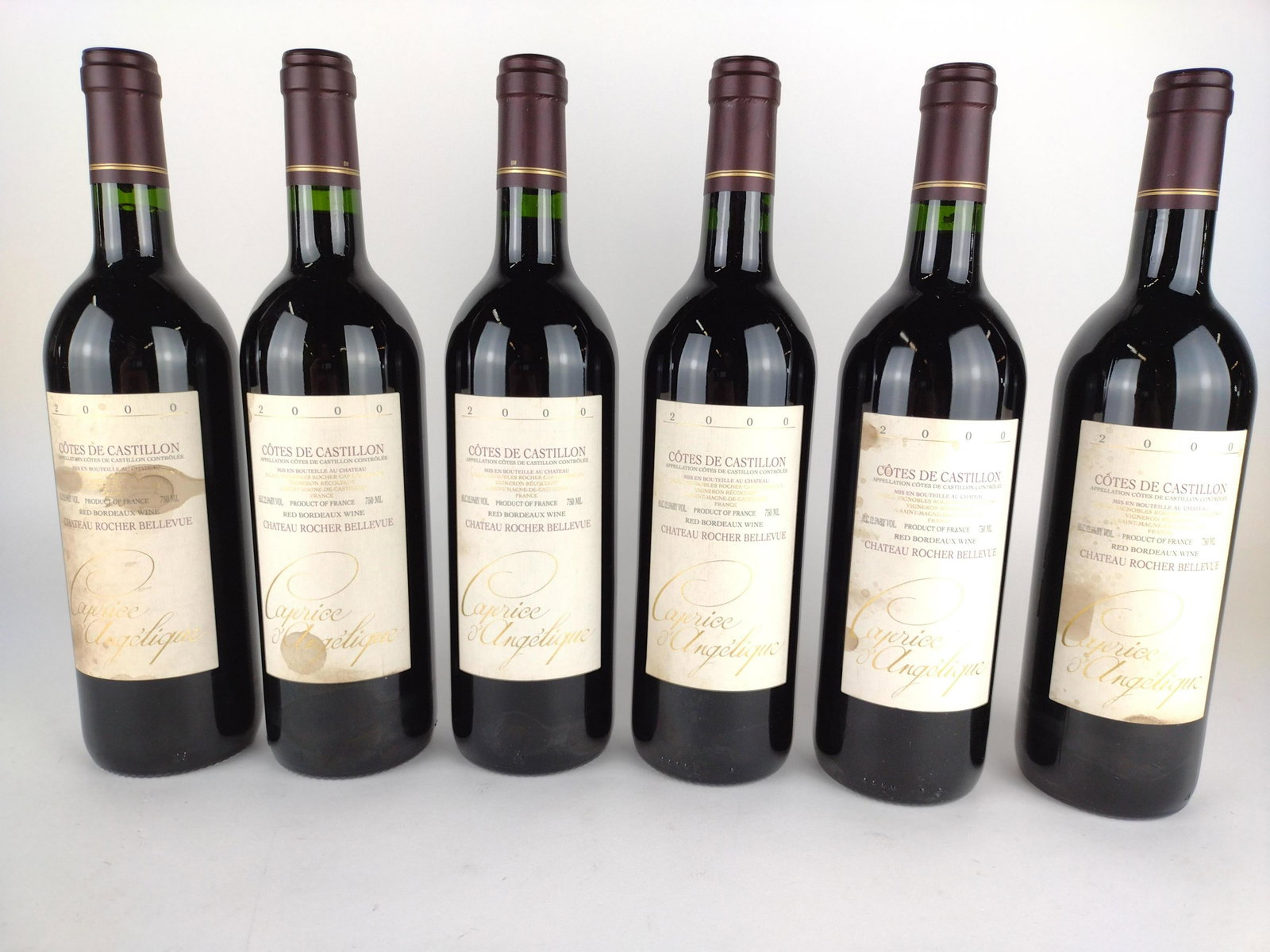 6 Estate Bottles Cotes De Castillon Bordeaux Wine: 2000.THIS LOT IS FACTORY SEALED. AVAILABLE FOR PICK UP ONLY. MUST BE 21 YEARS OF AGE. SHIPPING NOT AVAILABLE. Spots and stains to labels. KE. IMPORTANT: Before bidding, please read the terms and condi
