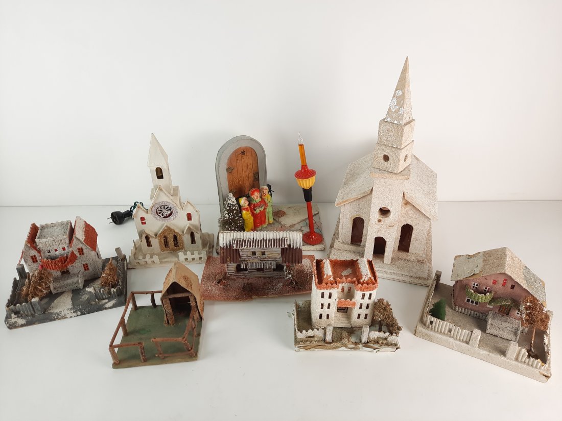 8 Christmas Village Buildings and Accessories: Includes carolers with bubble light lamp post. 4-1/2" to 16" high. Lights working. IMPORTANT: Before bidding, please read the terms and conditions. When you registered for the auction you agreed to th